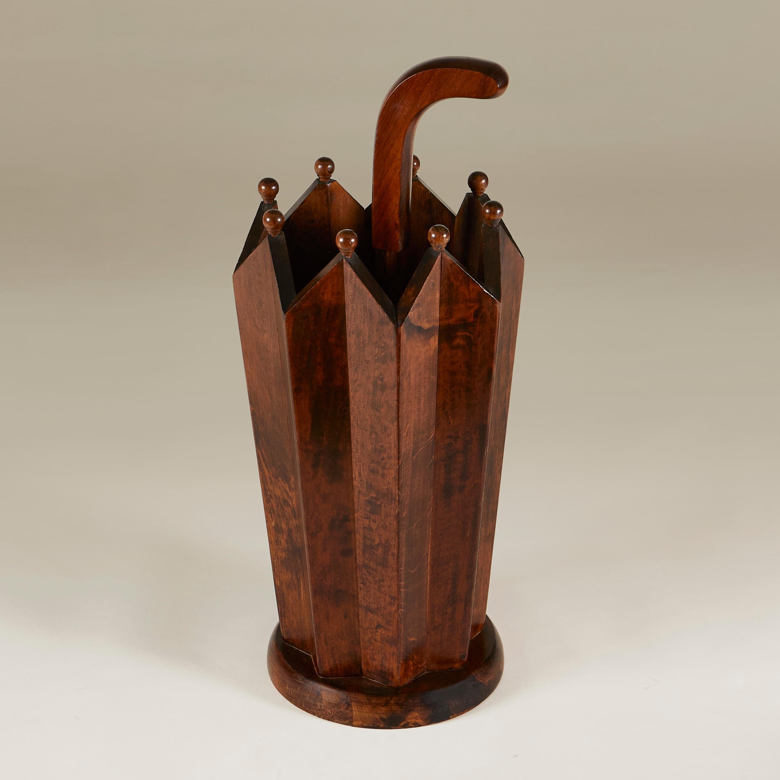The clue is in the shape! Dark wooden umbrella stand shaped like an umbrella.