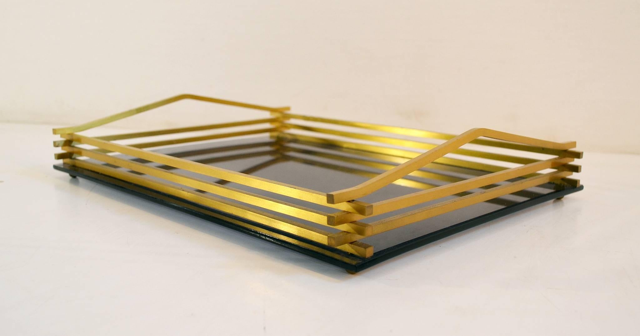 Italian rectangular smoke colored Lucite and brass tray standing on small brass ball feet.