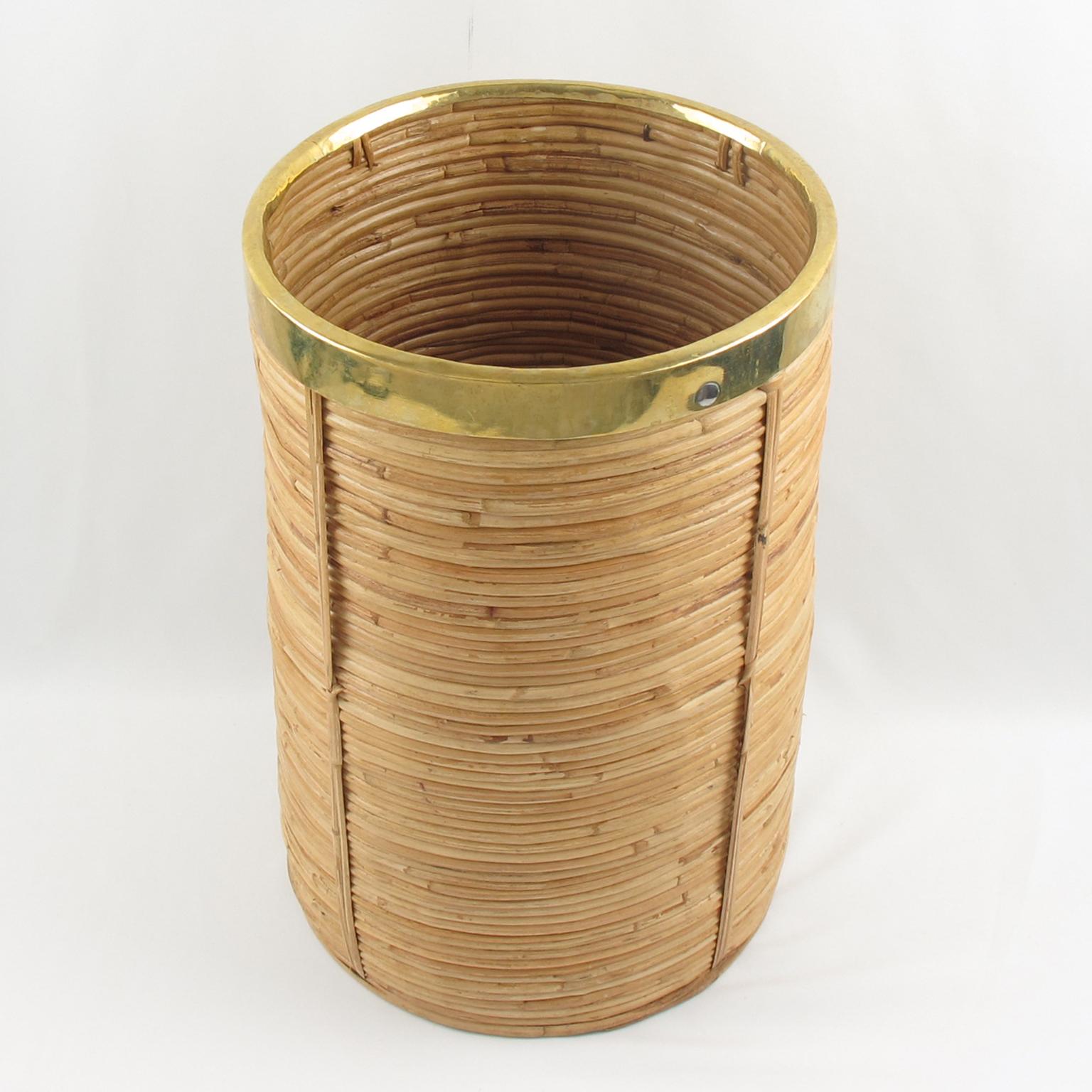 Elegant 1970s brass and bamboo, rattan or wicker tall planter or umbrella stand, reminiscent of Gabriella Crespi work. Round shape with gilded brass trim. No visible marking.
Measurements: 10.25 in. diameter (26 cm) x 15.75 in. high (40 cm).