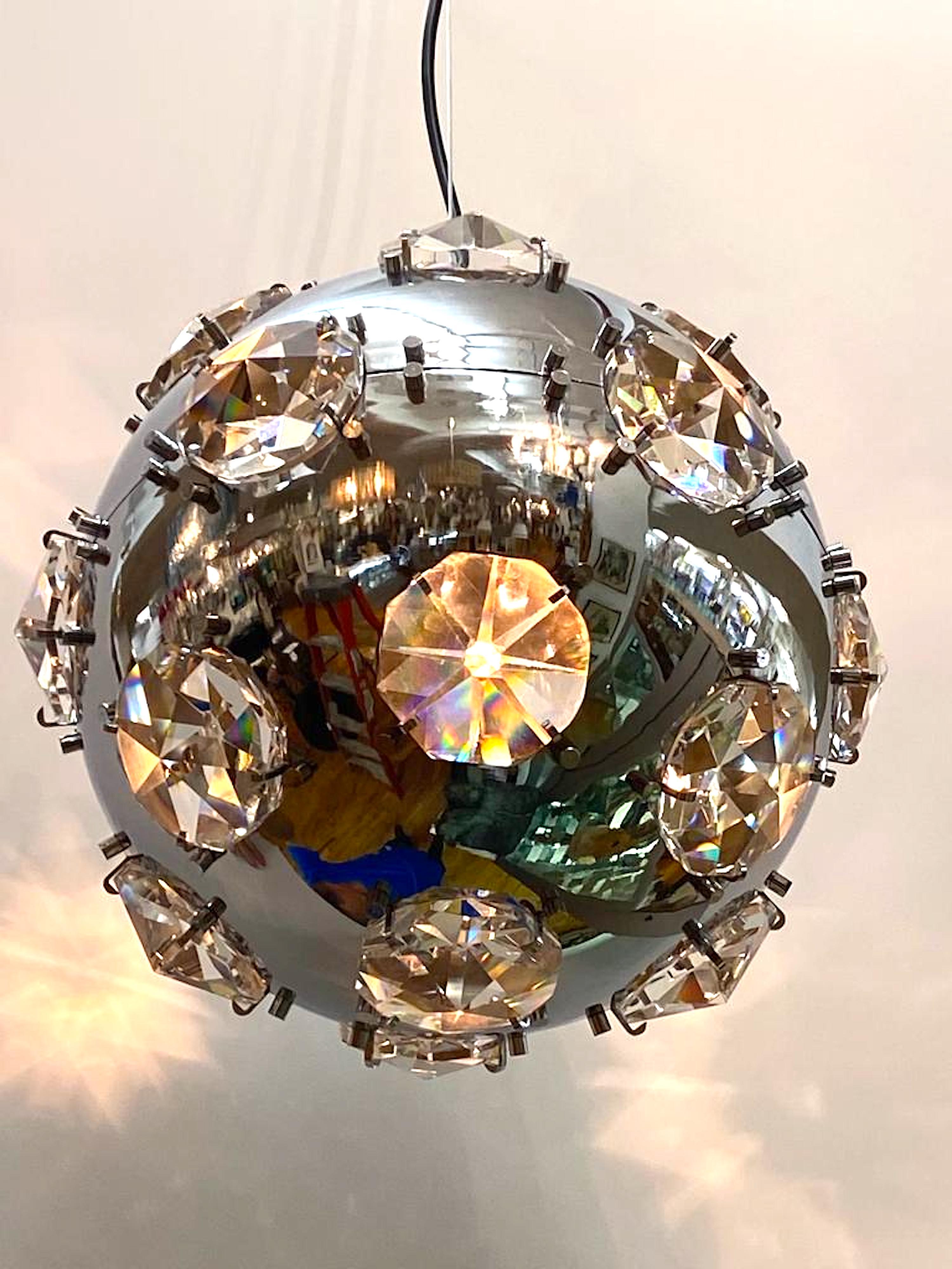 Très cool et chic suspension italienne des années 1970 en chrome et cristal à la manière du designer Oscar Torlasco. Le globe chromé de 10 pouces de diamètre est monté avec des cristaux taillés à facettes sur 8 côtés, d'un diamètre d'environ 2,5