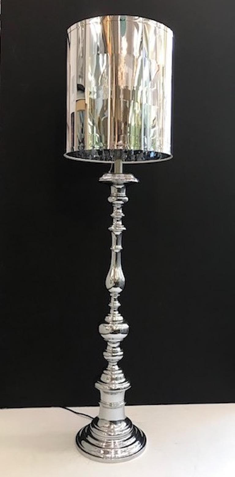 A chic Italian 1970s chrome floor lamp with custom shade. Made in the style of a turned wood candlestick but in chrome. New custom made heavy duty matching shade in heavy synthetic Mylar. The base of the floor lamp is 11 inches in diameter and