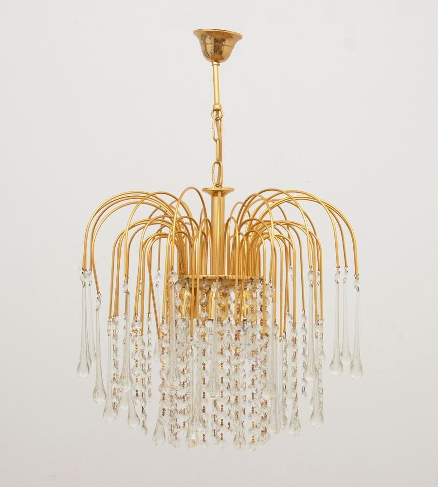 Italian 1970s gold-plated pendant light with tear drop crystals which we have had professionally re wired.
This is a really beautiful chandelier especially when illuminated.