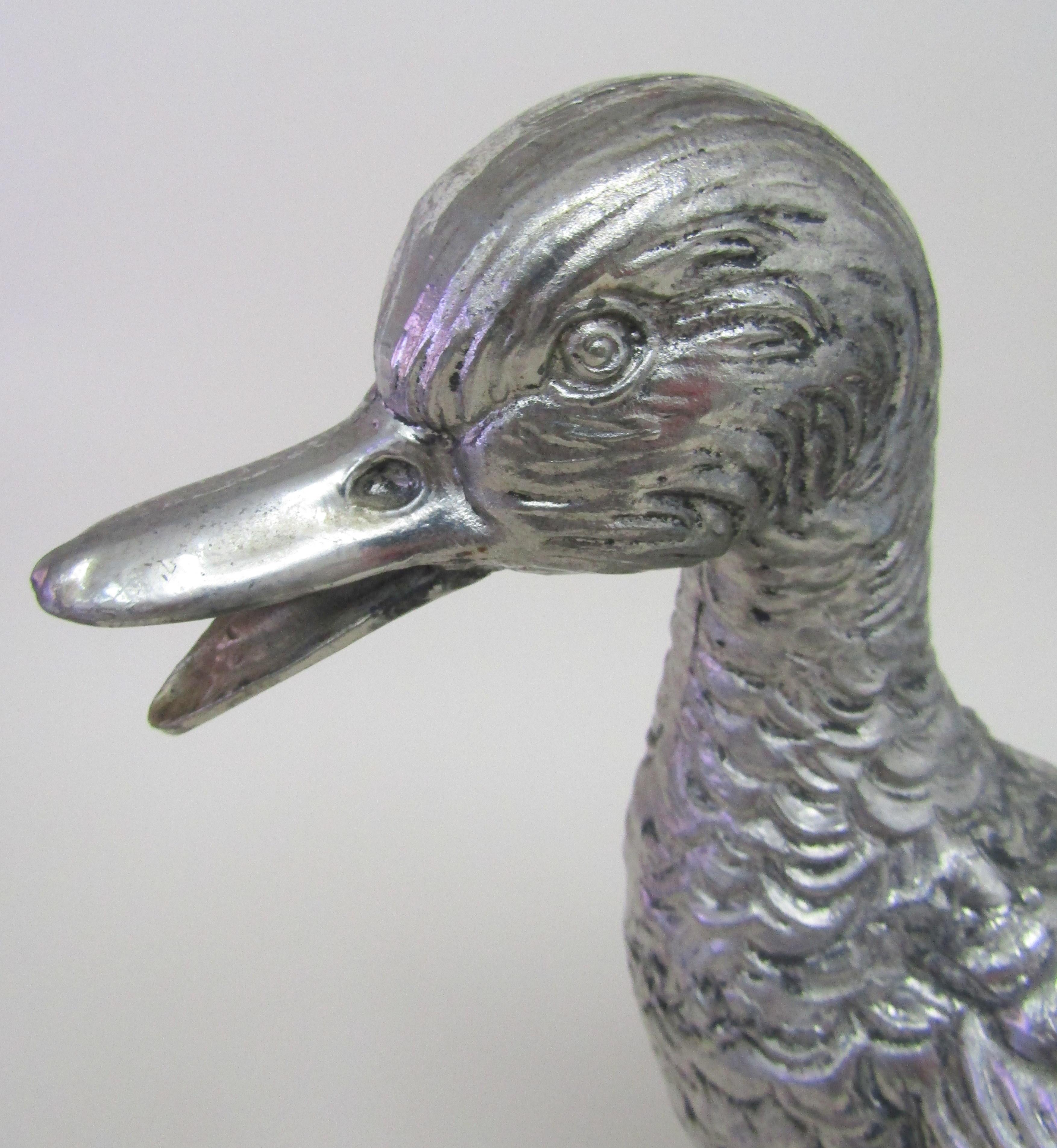 An Italian 1970s handmade pewter model of a duck by Mauro Manetti with original hanging label and sticker attached
Signed M/M and inscribed LEGA PELTRO MADE IN ITALY FIRENZE.

Measures: Height 10 ½ in / 27 cm.