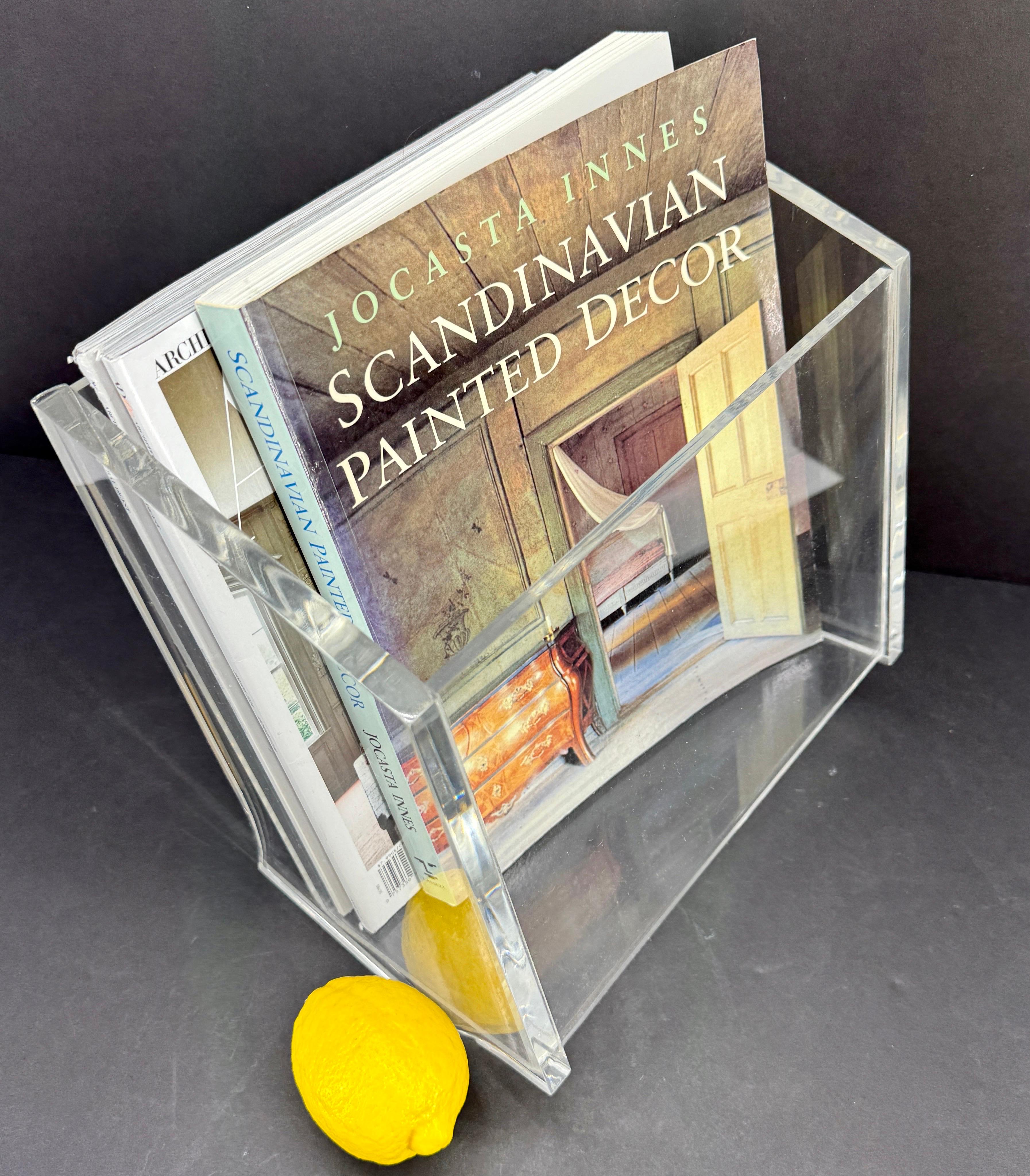 Mid-Century Modern Magazine Rack in Thick Lucite, Italy 1970's

This eye-catching lucite magazine rack or stand was hand crafted to stand tilted slightly backwards. 
The inside measurements are 9.75 inches in width, 4.95 inches in depth and 10.25