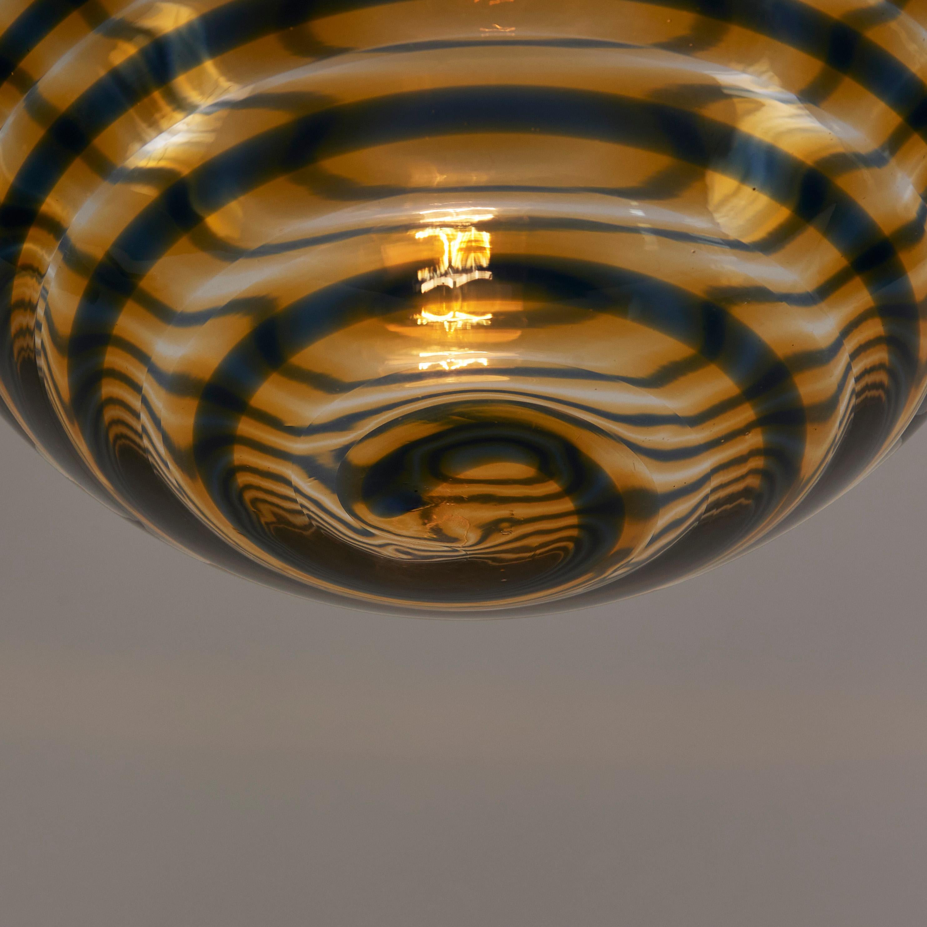 Brass Italian 1970s Murano amber and black swirl ball pendant