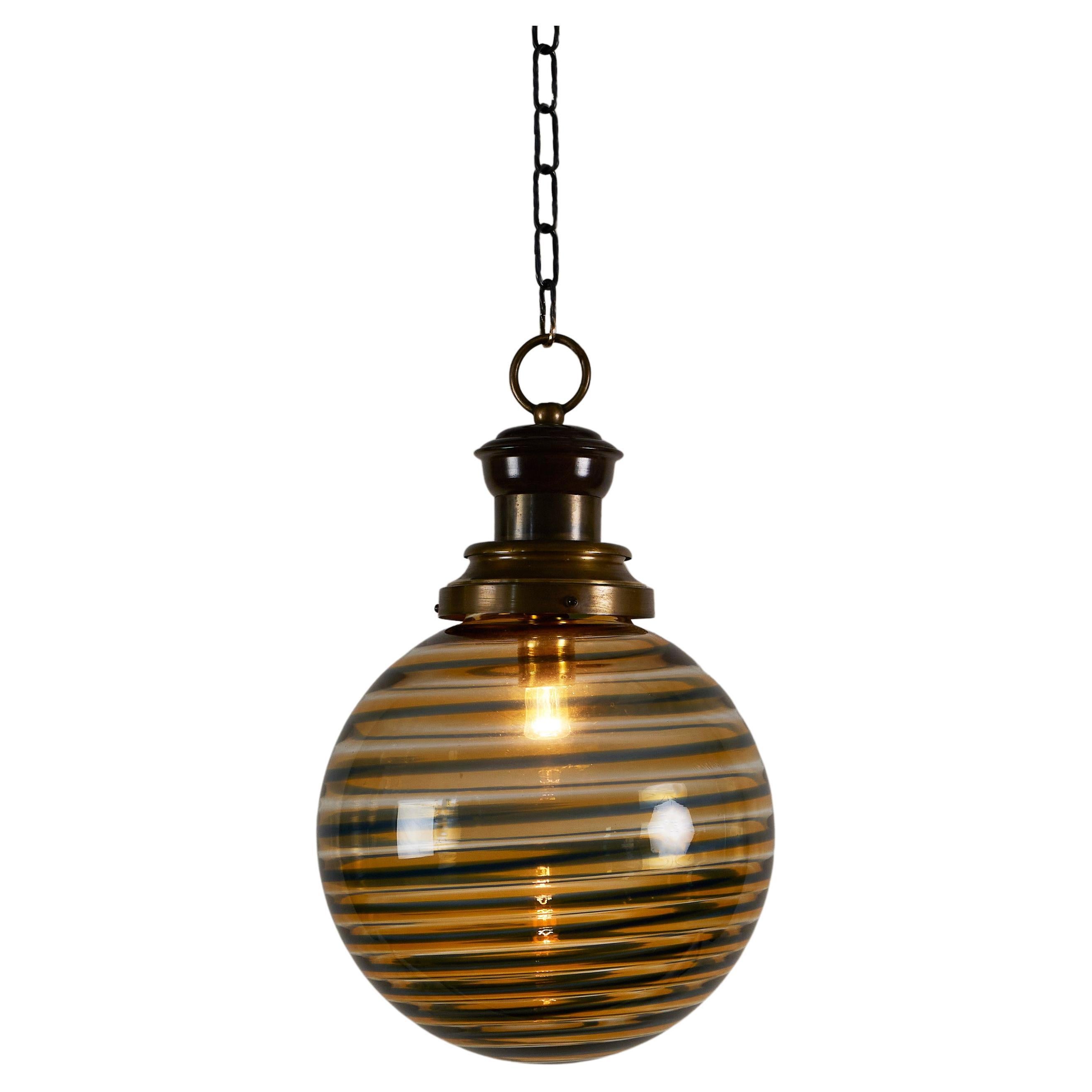 Italian 1970s Murano amber and black swirl ball pendant For Sale