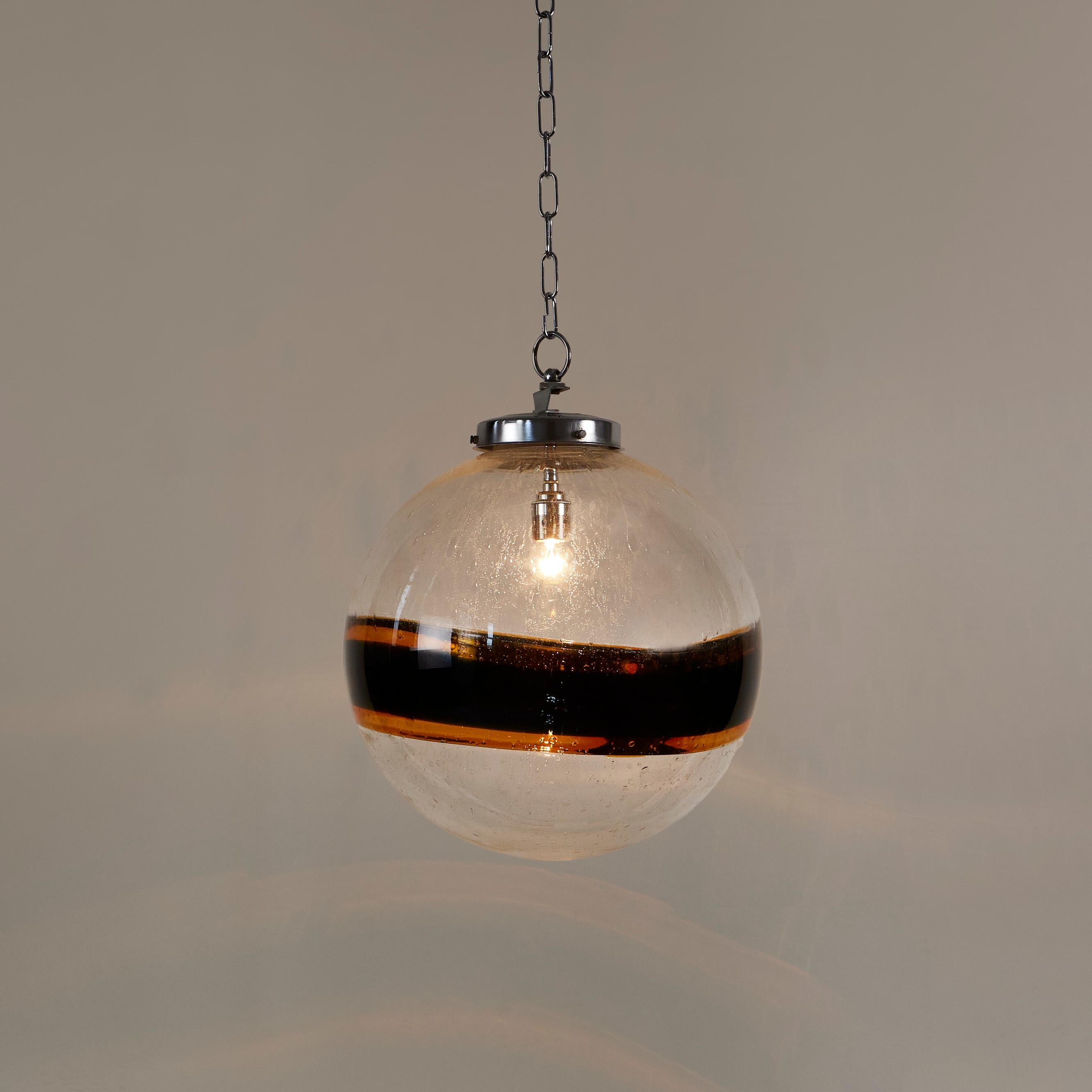 Murano handblown glass ball pendant of transparent bubble patterned clear glass with decorative thick black and gold stripe. Chrome fitting.
