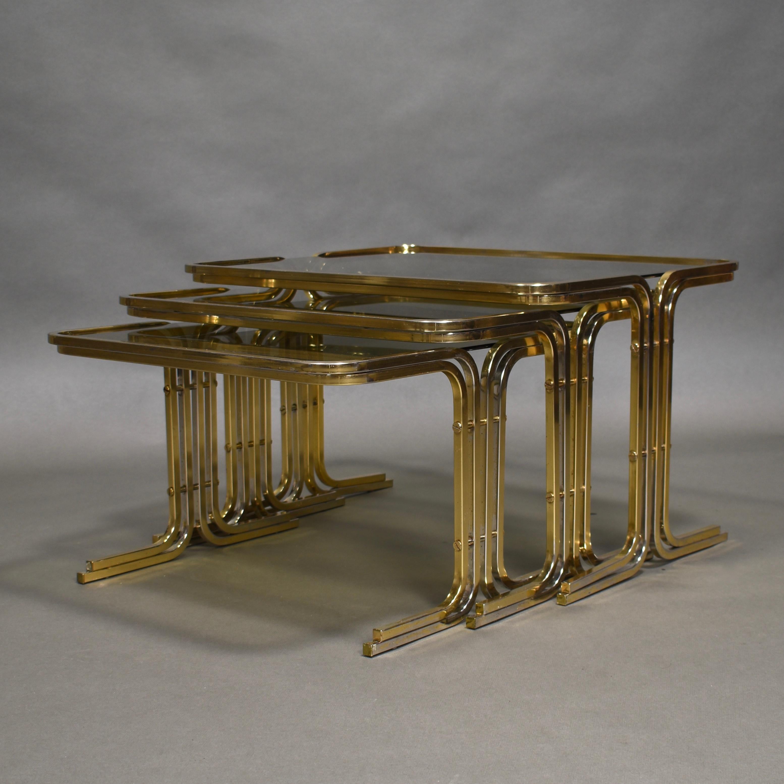 Amazing set of three gold colored Italian 1970s nesting tables. The set resembles a Great Gatsby or Hollywood Regency style.

Designer: Unknown

Manufacturer: Unknown

Country: Italy

Model: Nesting tables

Material: Metal / Smoked