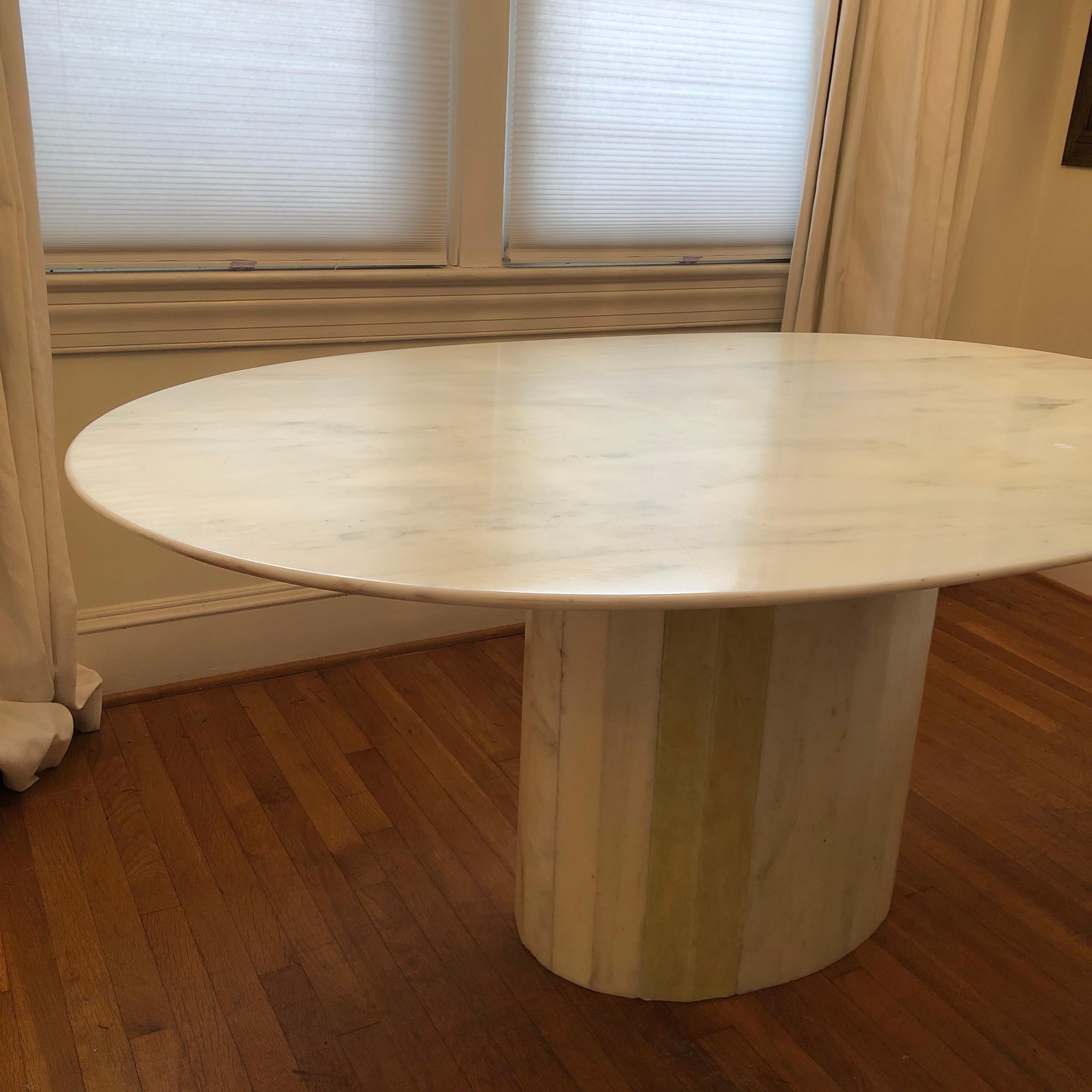 Beautiful ash marble with green veining. Oval shape top sits on matching pedestal base. 
Mid-Century style fits well in contemporary or modern home. 

Measures 65 x 39.5 x 28.5 

Offering this table at a discount as it does have a small chip on