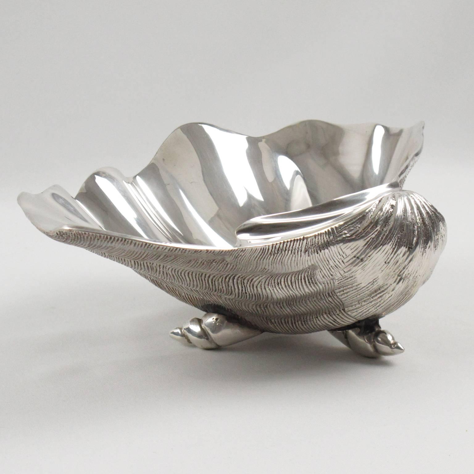 Very elegant Italian midcentury silver plate clam shell bowl. Large dimensional shape with textured pattern on the outside and shiny polished finish on the inside. Three tiny shells as feet. No visible marking.
Measurements: 10.63 in. wide (27 cm)