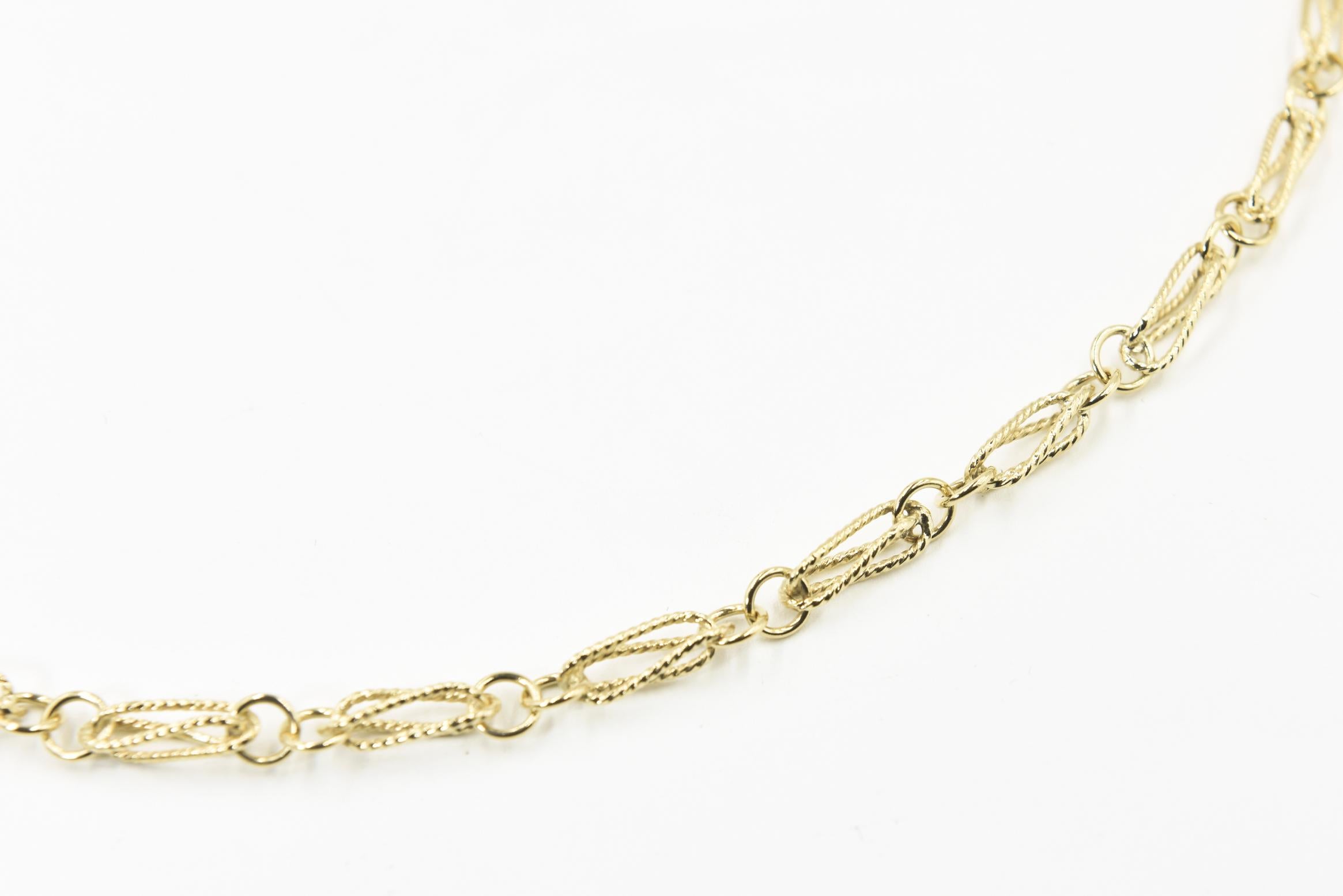 Highly stylized Italian 18k yellow gold necklace featuring an open oval twisted gold links rotating with smooth gold circles.  It closes with a jump ring.
Marked  750 and 61 VI 
