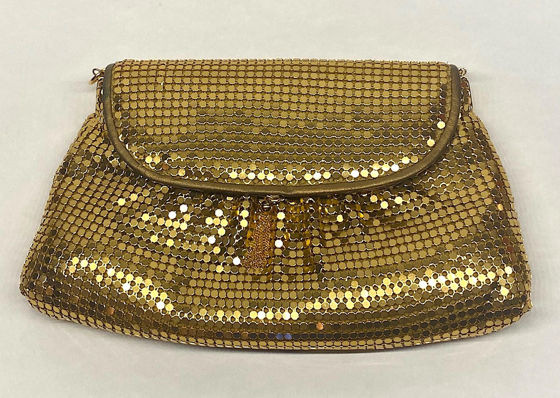 The perfect bag to spend the night on the dance floor at the disco by Italian hand bag and accessory company Marlon Firenze. The exterior is gold mesh with light ruching on the front and back. The bag has a fold over postman style flap with gold