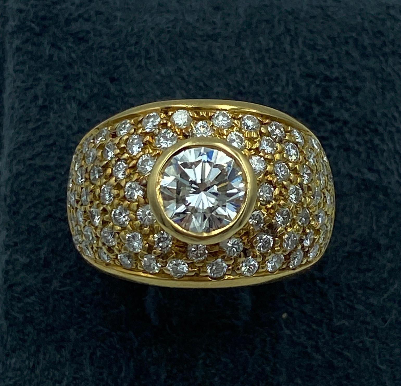 A stunning Italian made 1990s dome cocktail ring consisting of a round cut centre diamond of approximately 0.9 carat and 75 small diamonds of approximately 2.25 carats. Made of 18 carat gold, it is a beautiful piece which you will not want to take