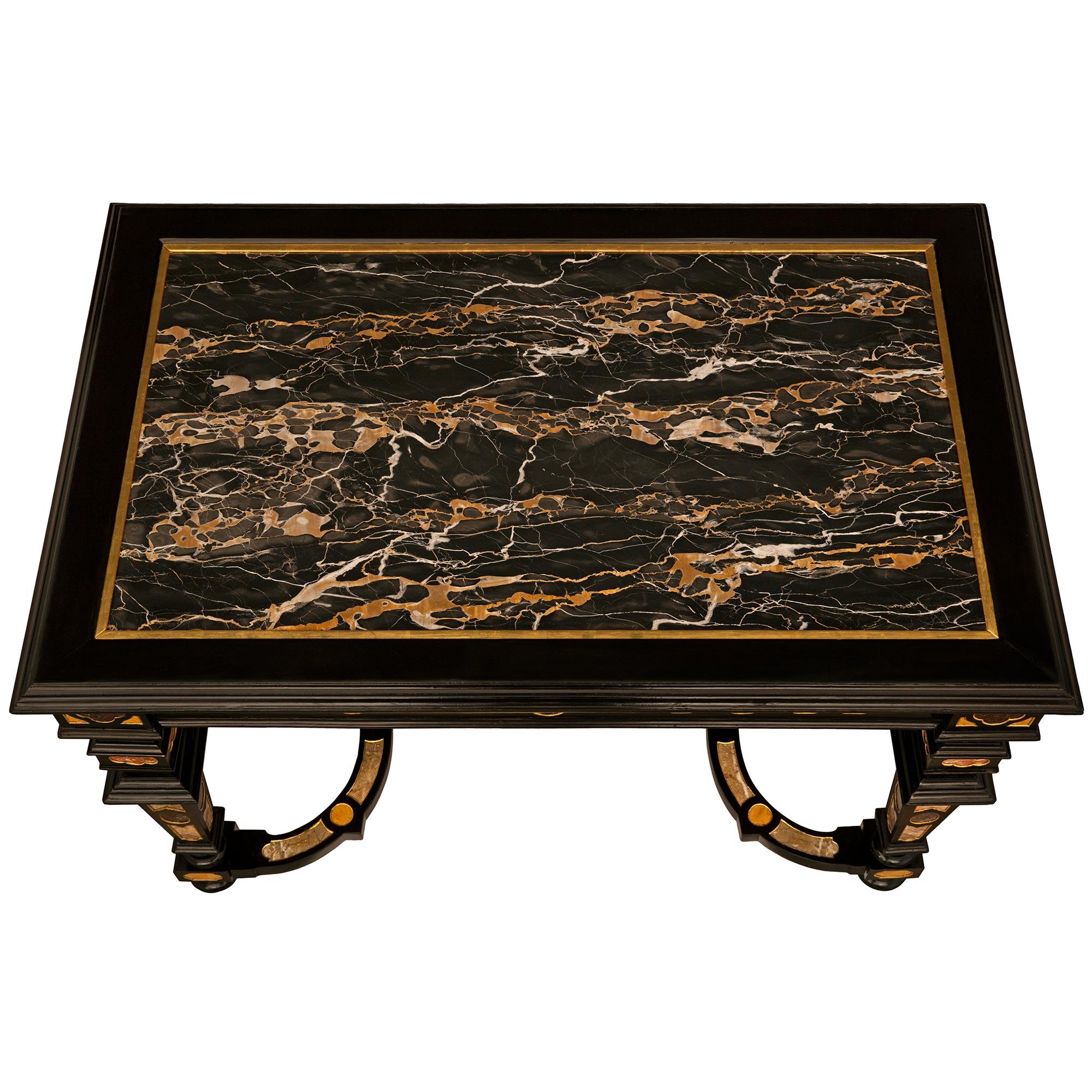 A striking and uniquely detailed Italian 19th century Baroque st. ebonized Fruitwood, Giltwood, Portoro marble, faux Porphyr, and Semi Precious Stone center table. This exquisite rectangular table is raised by handsome square tapered legs and topie