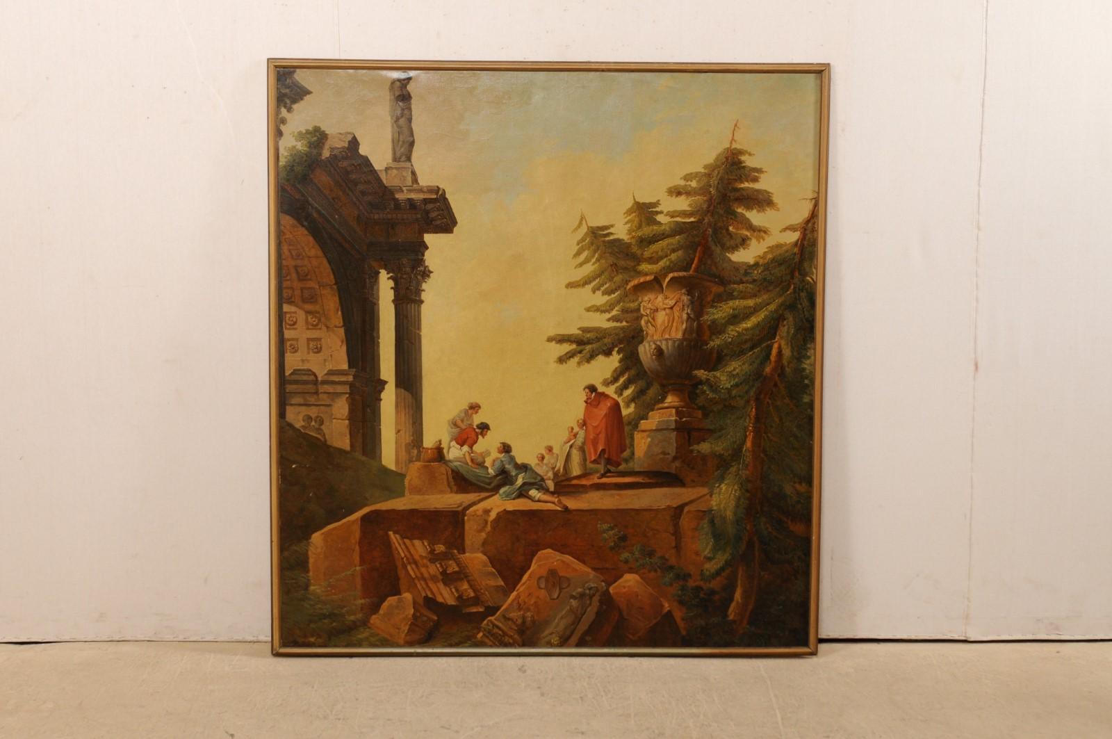 An Italian large-sized painted wall panel from the 19th century, artist unknown. This antique artisan painted and framed wall panel from Italy is a lovely capriccio depicting a classical Romanesque ruins landscape animated with maidens playfully