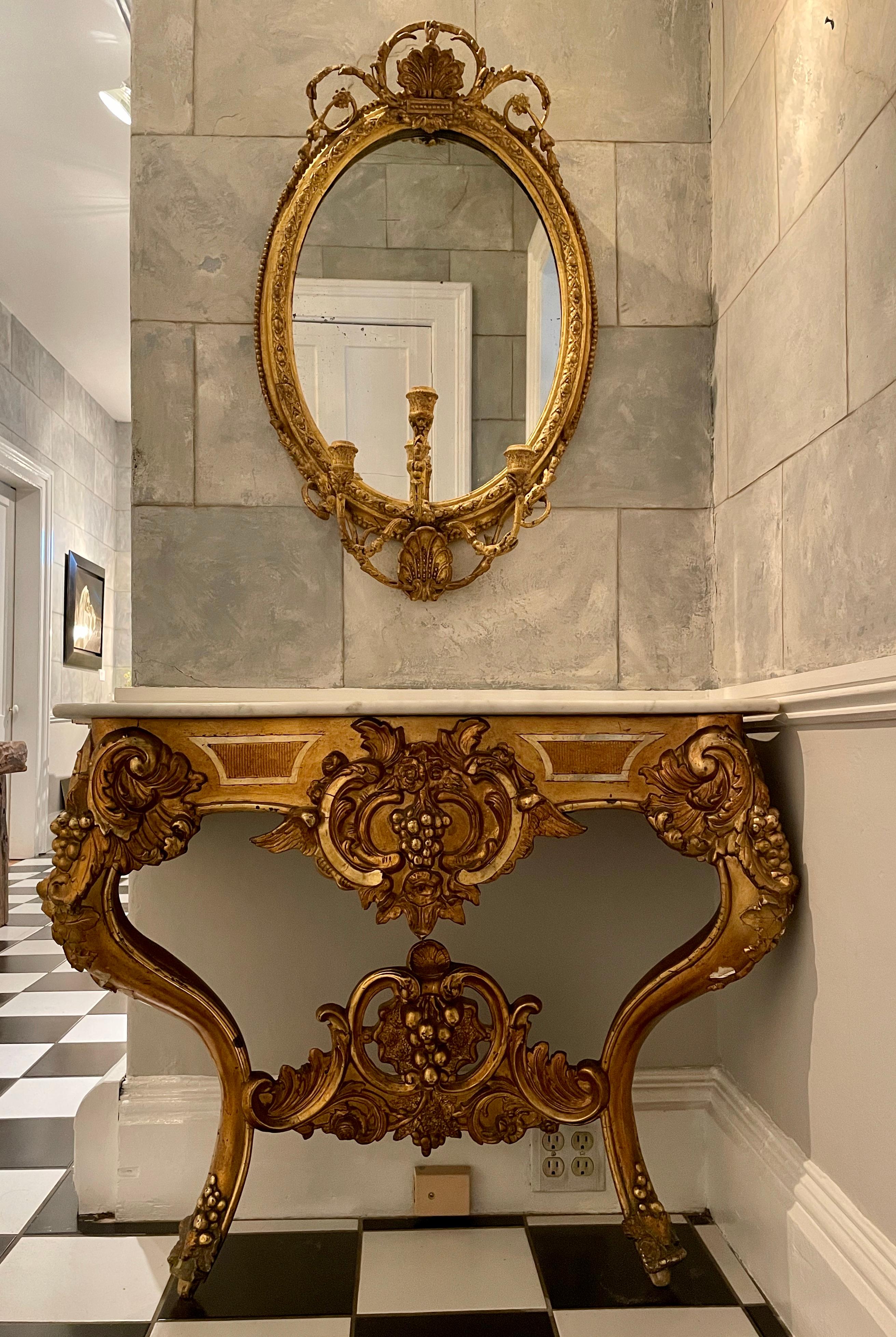 This stunning Italian table has enough sparkle to lift an entire room! The wooden base is beautifully carved and water-gilded with three different shades of gilding--a rich golden yellow, a mellow golden-pink, and a lighter matte gold, so it is not