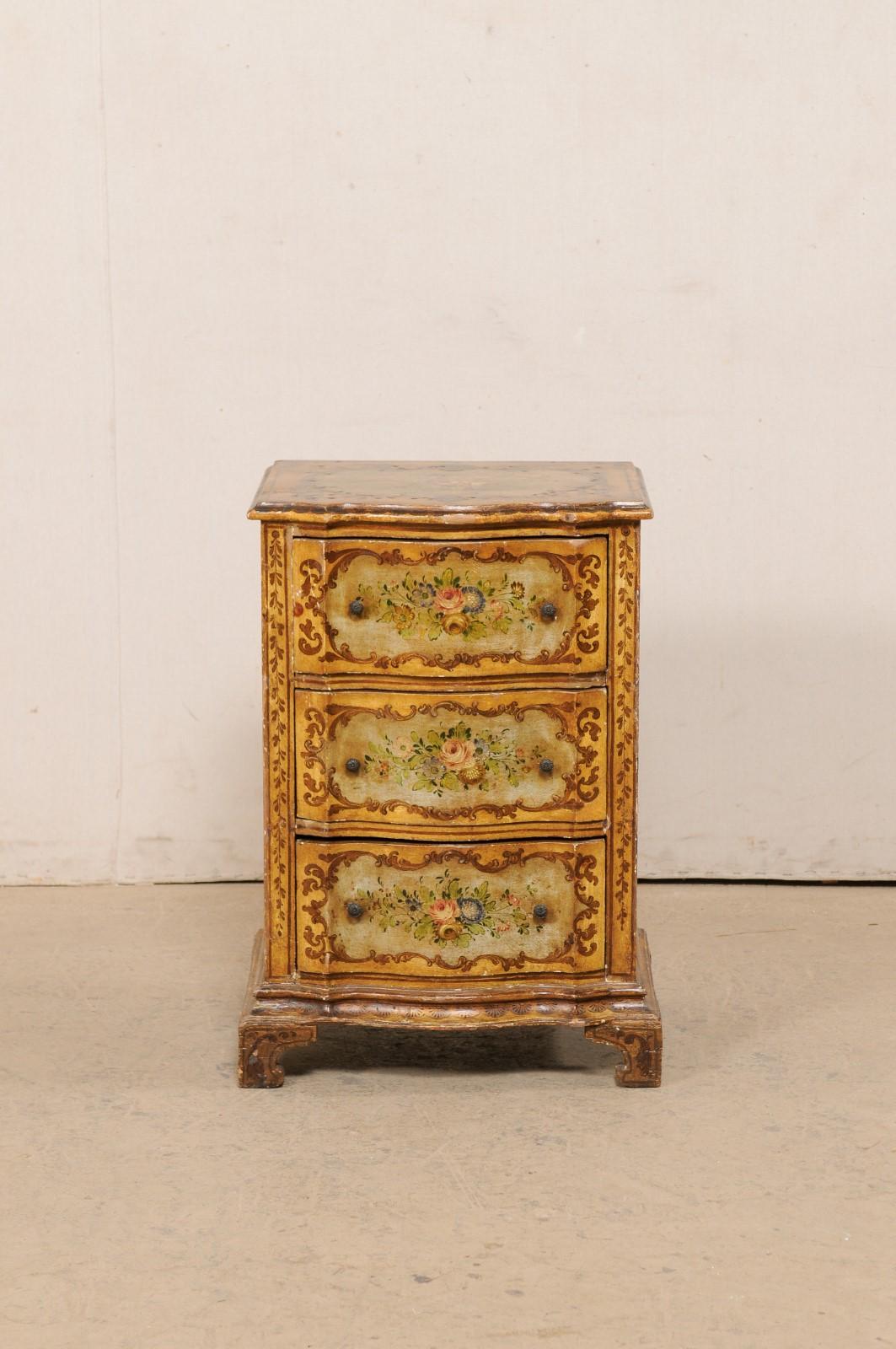 An Italian smaller-sized serpentine chest of drawers, with hand-painted floral embellishments, from the 19th century. This antique commode from Italy has a shapely serpentine facade, houses three drawers, and is presented on carved bracket feet. The