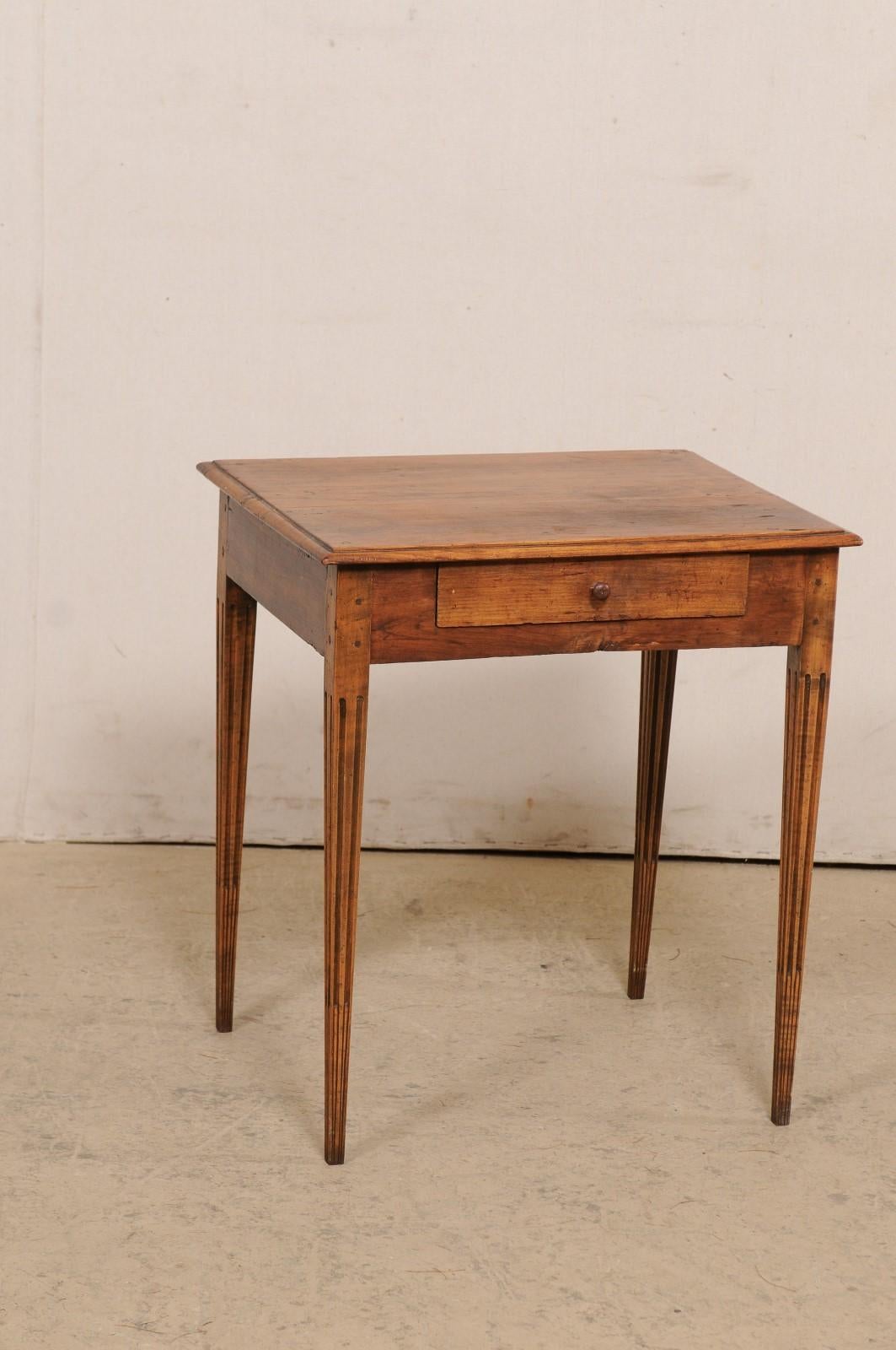 An Italian side table with single drawer from the 19th century. This antique table from Italy features a 24