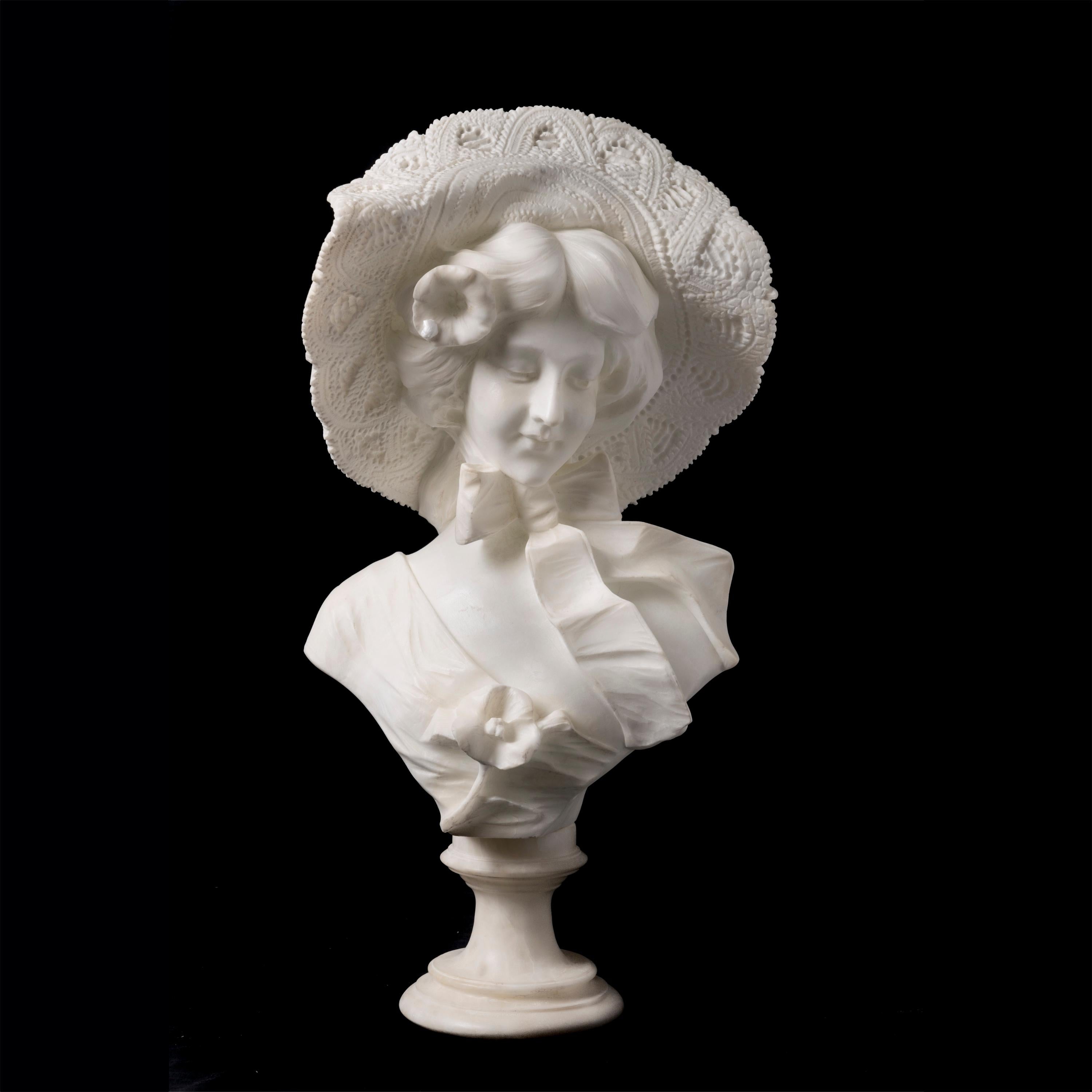 An alabaster bust of a lady wearing a bow around her neck, her large hat gently perched on her coiffed hair. Signed 