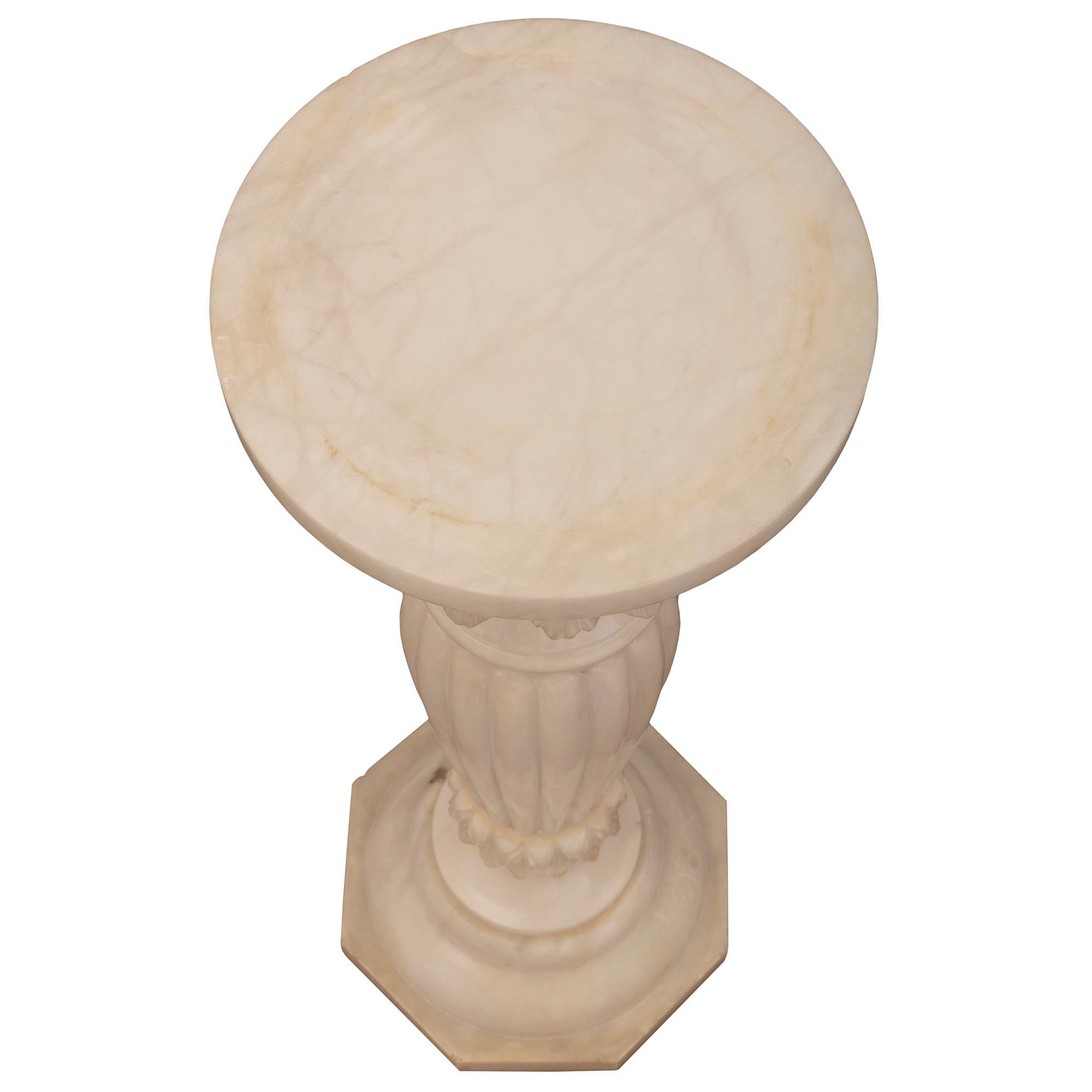 A beautiful Italian 19th century Alabaster pedestal column. The pedestal is raised by an octagonal base below a circular mottled element. The baluster shaped central support displays beautiful richly sculpted foliate designs and an impressive reeded