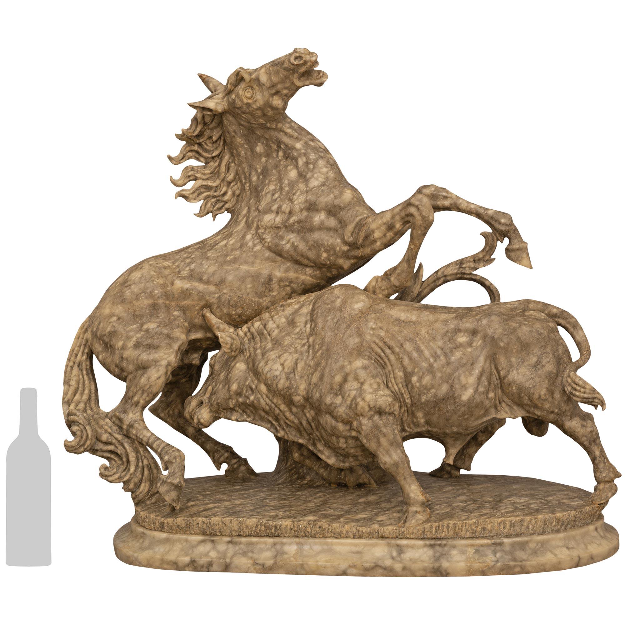 An impressive and intricately detailed Italian 19th century Alabaster statue of a horse and bull in battle. This fierce scene of a horse being gored by a bull displays a powerful and majestic clash between two magnificent beasts. The details of the