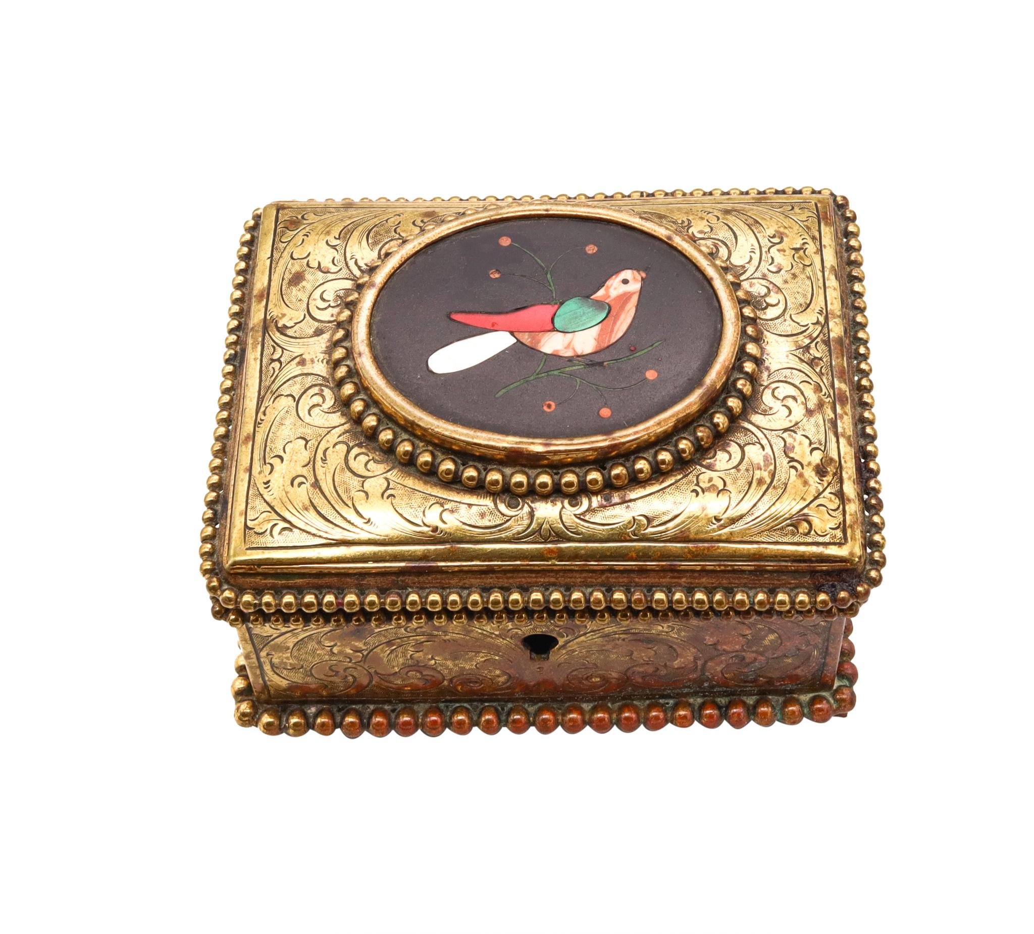 A Pietra Dura brass box.

Beautiful antique little box, created probably in Napoles, Italy as a treasure chest, circa 1880s. It was crafted in solid gilded brass with nice Baroque engravings of organics motifs. Embellished on top, with an oval