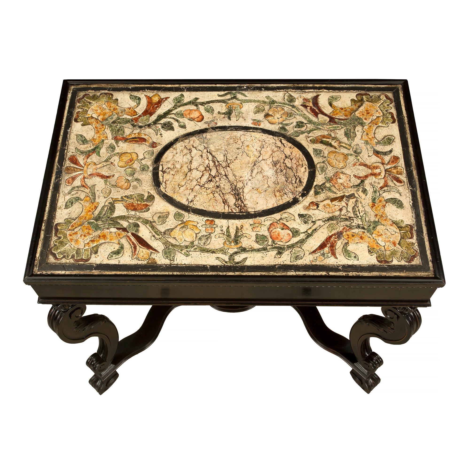 A most attractive and unique Italian 19th century Baroque st. ebonized fruitwood and Scagliola center table. The rectangular table is raised by four 'S' scrolled legs with a reeded outer design and acanthus leaves at the back. The legs are joined by