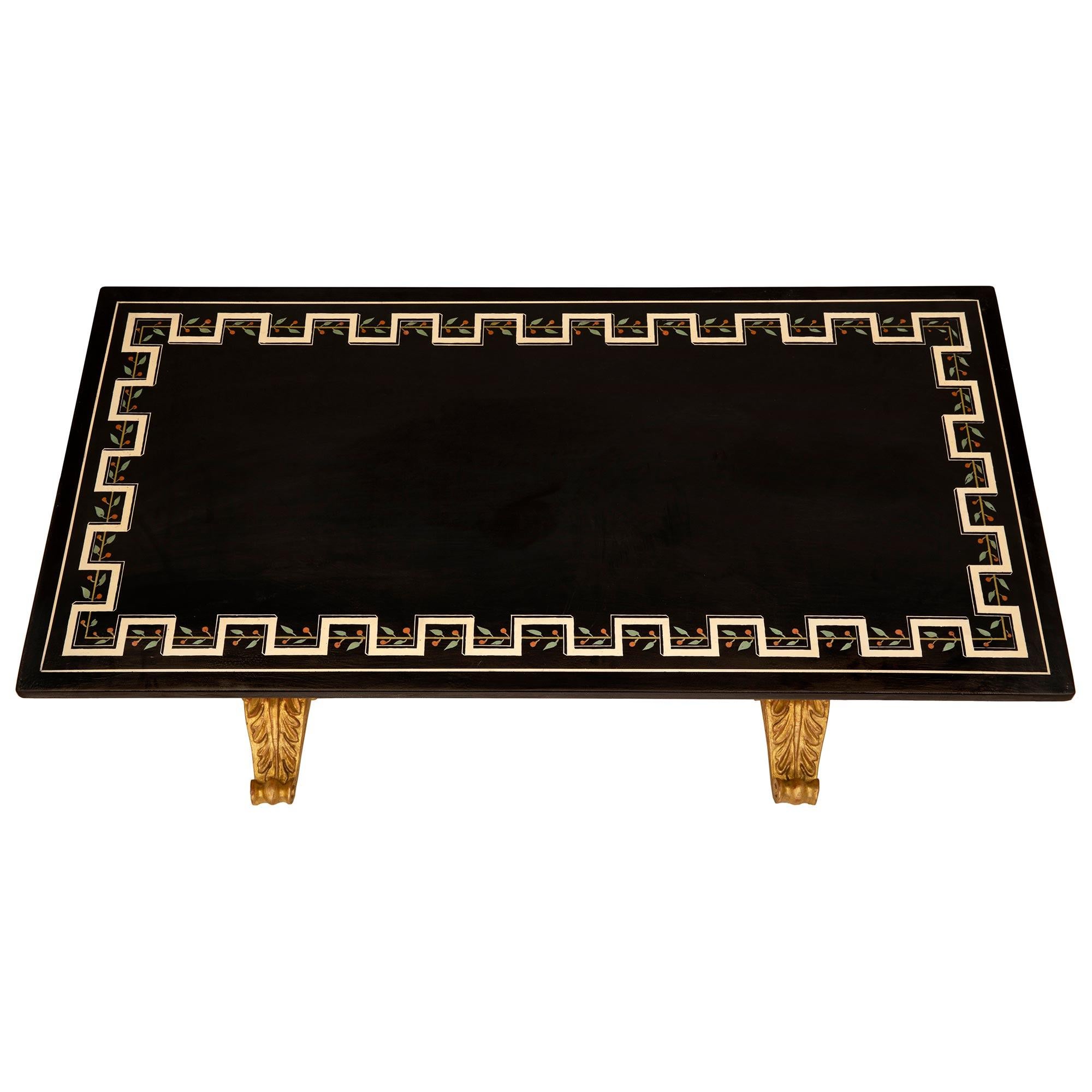 A striking Italian 19th century Baroque st. giltwood and patinated wood coffee/cocktail table. The rectangular table is raised by a beautiful giltwood base with lovely most elegant scrolled acanthus leaf feet below a fine fluted block reserve with a