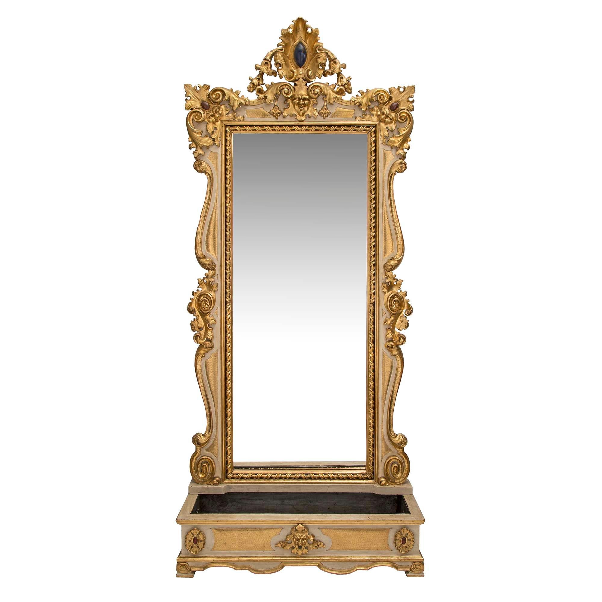 A most decorative and unique Italian 19th century Baroque st. patinated and giltwood mirror with its original matching planter. At the base is the elegant planter with a removable pewter insert. Raised by mottled feet below a scalloped shaped frieze