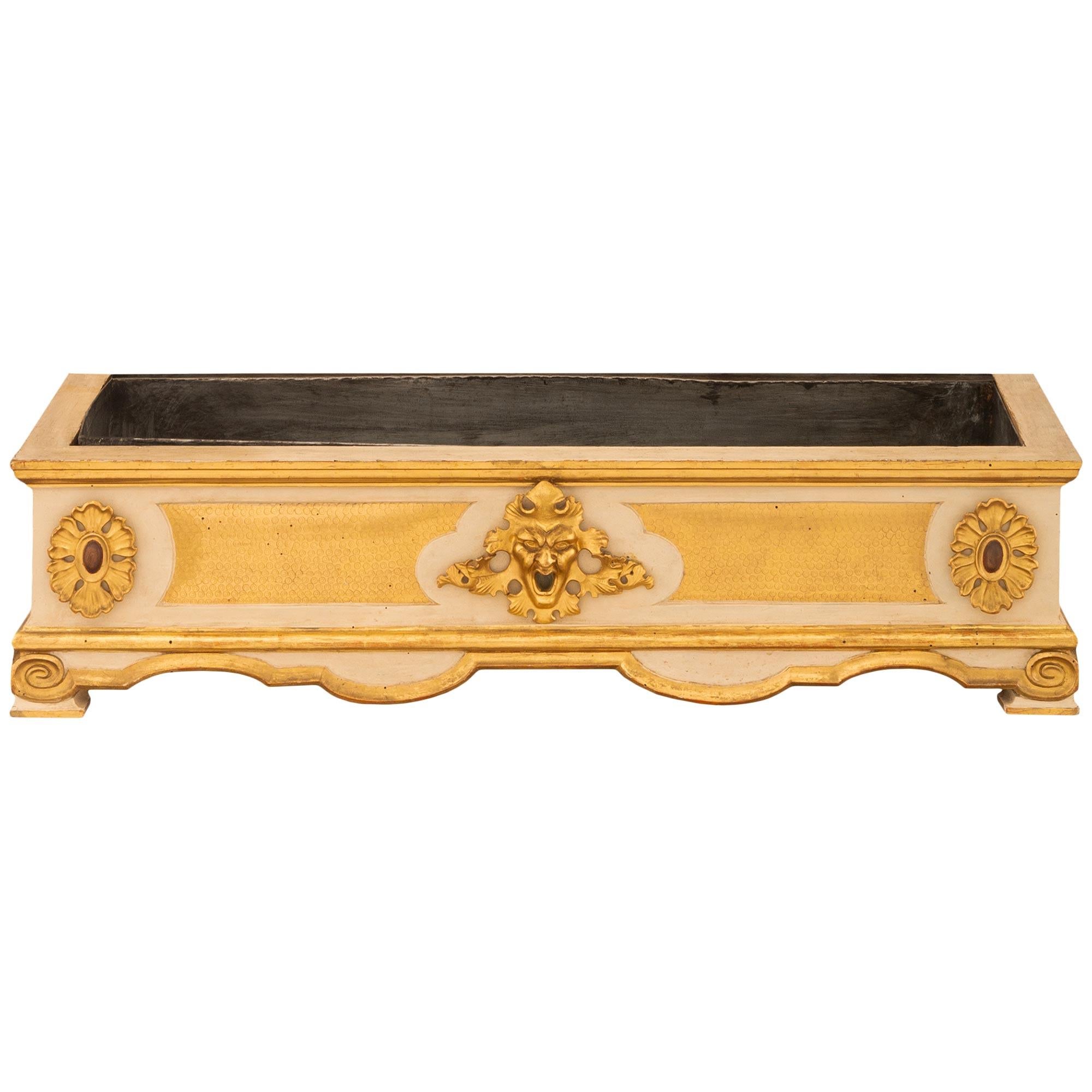 A most decorative and unique Italian 19th century Baroque st. patinated wood and Giltwood planter. The planter is raised on mottled feet below a scalloped shaped frieze with a beautiful Giltwood band. At the front center is an impressive and finely