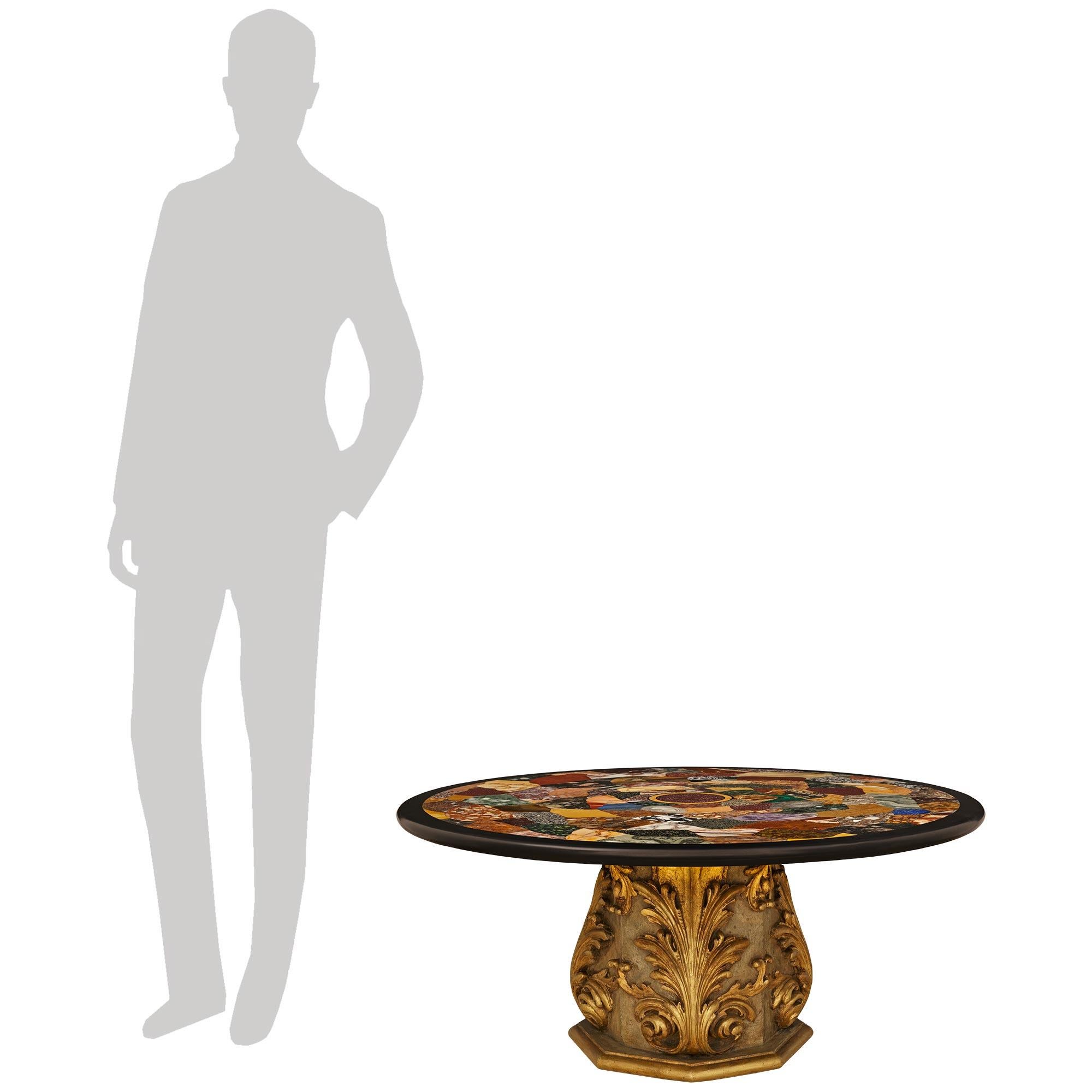An impressive and most decorative Italian 19th century Baroque st. Specimen Marble and Giltwood coffee table. This exceptional table is raised on an octagonal base with a mottled Giltwood band below the patinated wood pedestal. Each of the eight