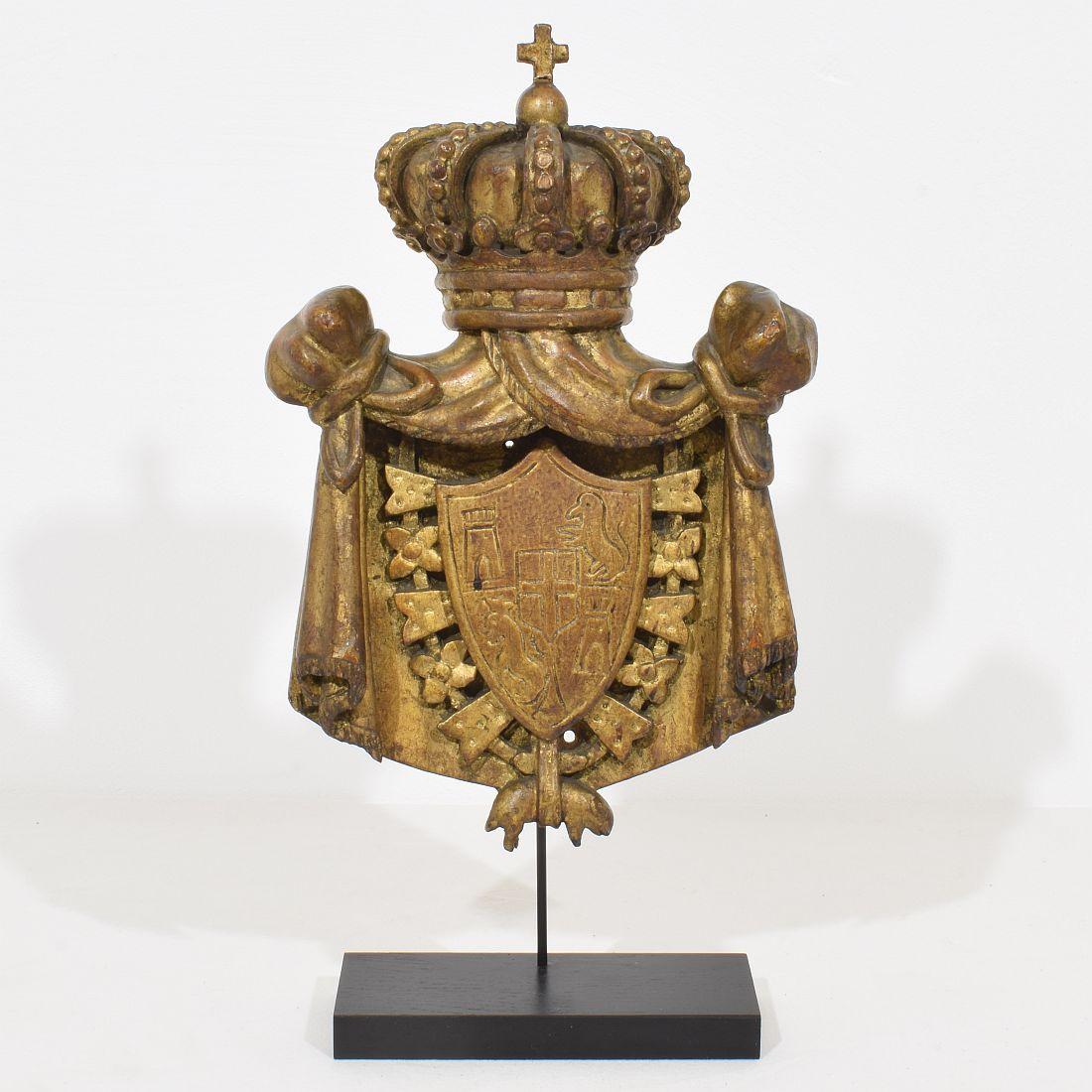 Wonderful hand carved wooden coat of arms, Italy, circa 1850. 
Weathered small losses and old repairs. Measurement includes the base.