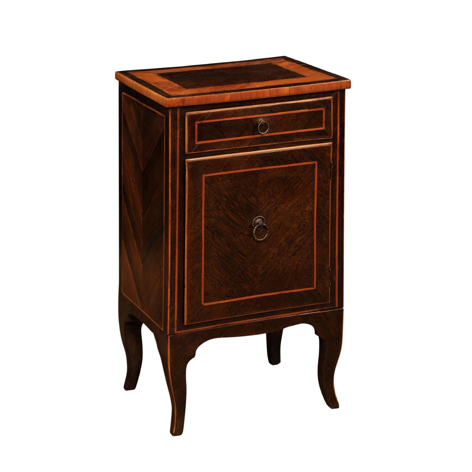 An Italian mahogany and walnut bedside table from the 19th century, with inlaid décor, single drawer over single door, pull out bottom and cabriole legs. Created in Italy during the 19th century, this bedside table captures our attention with its