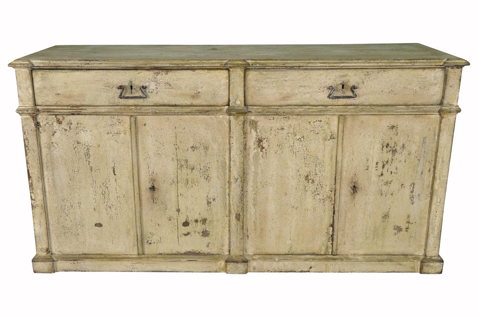 A very handsome early 19th century buffet or credenza from Northern Italy. Soundly constructed from painted wood with 4 doors and 2 drawers. Terrific patina and color. Great storage piece.