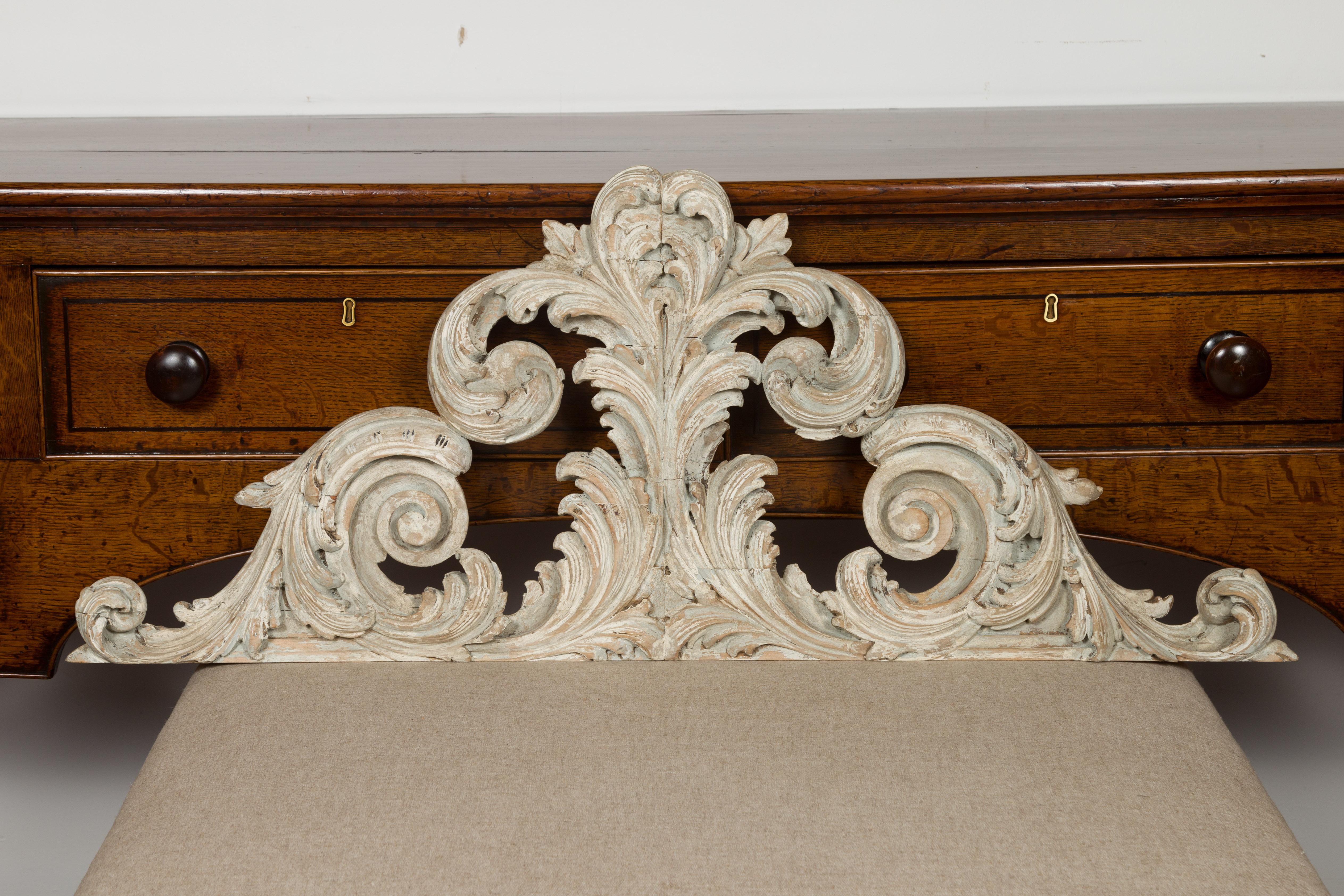 An Italian carved and painted architectural fragment from the 19th century, with volutes and acanthus leaves. Created in Italy during the 19th century, this carved fragment attracts our attention with its sinuous scrolling lines accented with carved
