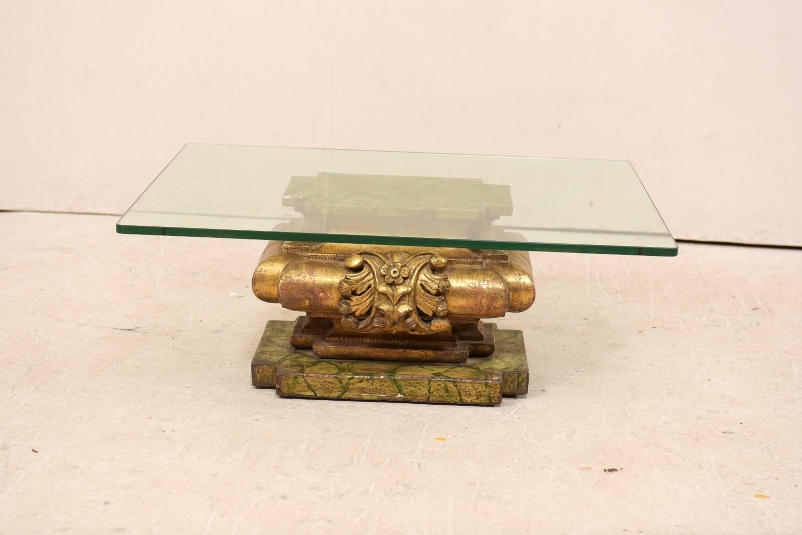 An Italian 19th century carved and giltwood coffee table with glass top. This luxurious little coffee table has been fashioned from an antique Italian giltwood fragment, carved with acanthus leaf and floral motif at each side, and topped with a
