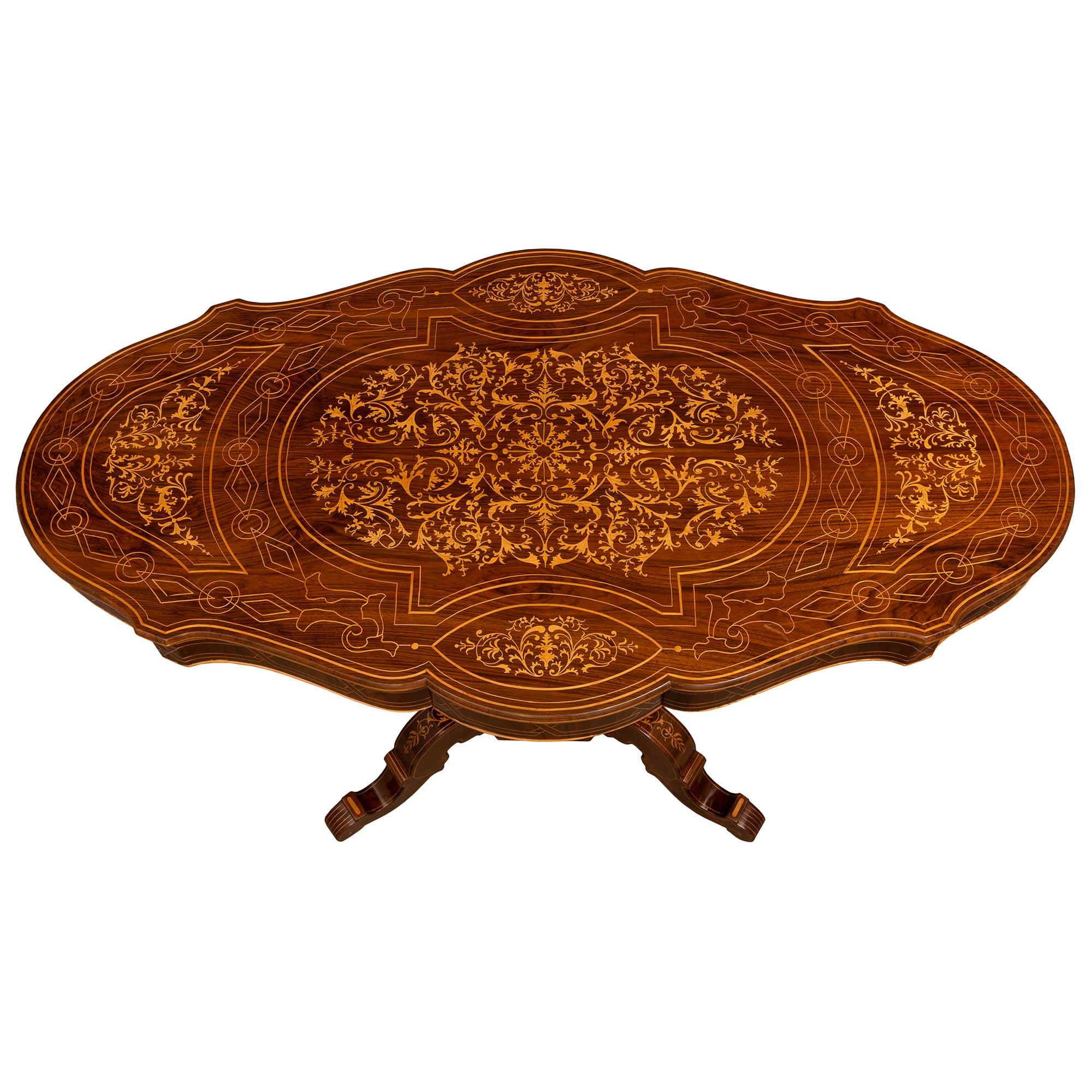 A beautiful and most decorative Italian 19th century Charles X period Walnut and Maplewood side/center table. The table is raised by four elegantly scrolled legs connected to a most decorative octagonal support decorated with charming intricately