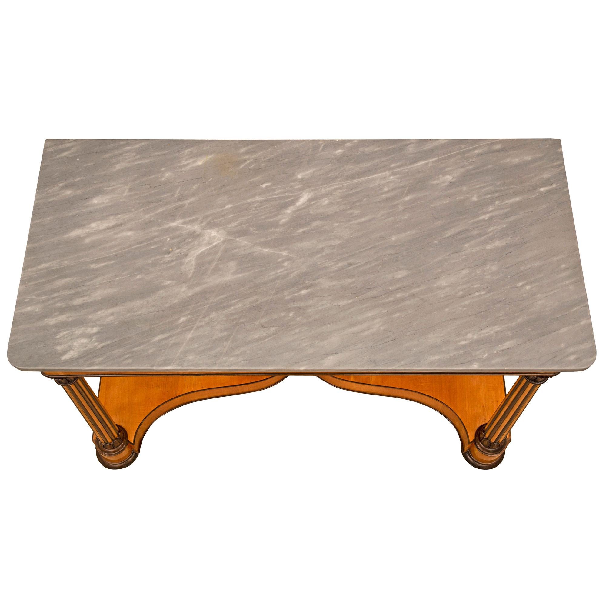 A handsome and extremely decorative Italian 19th century Charles X st. Cherrywood Birchwood and Gris St. Anne marble console. The uniquely designed freestanding console is raised by elegant bun feet below impressive lightly tapered circular fluted