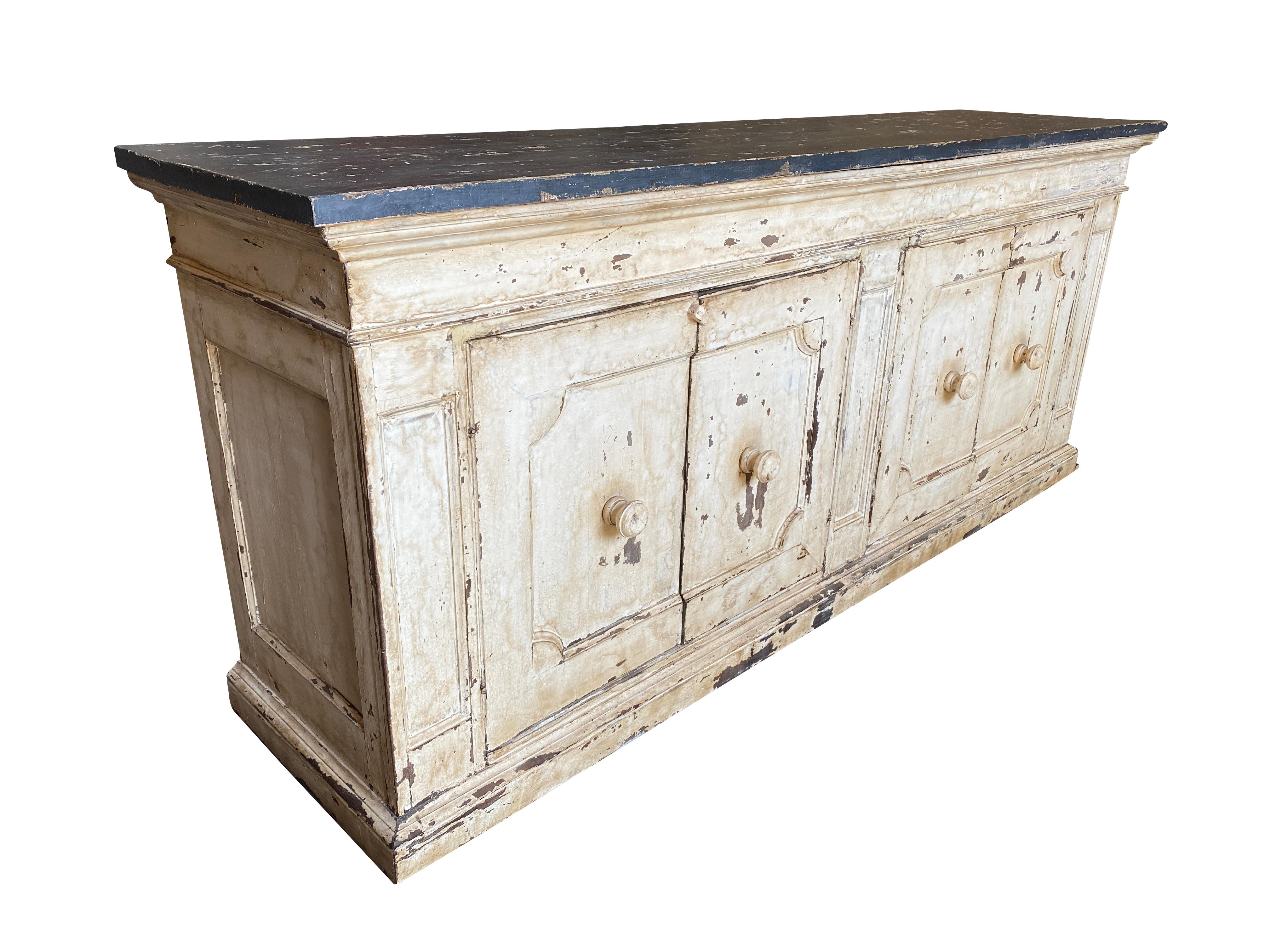 A very beautiful 19th century Credenza from the Lombardy region of Italy. Soundly constructed from painted wood with 4 doors, shelving resting on a plinth base. A great storage piece with nice narrow depth.