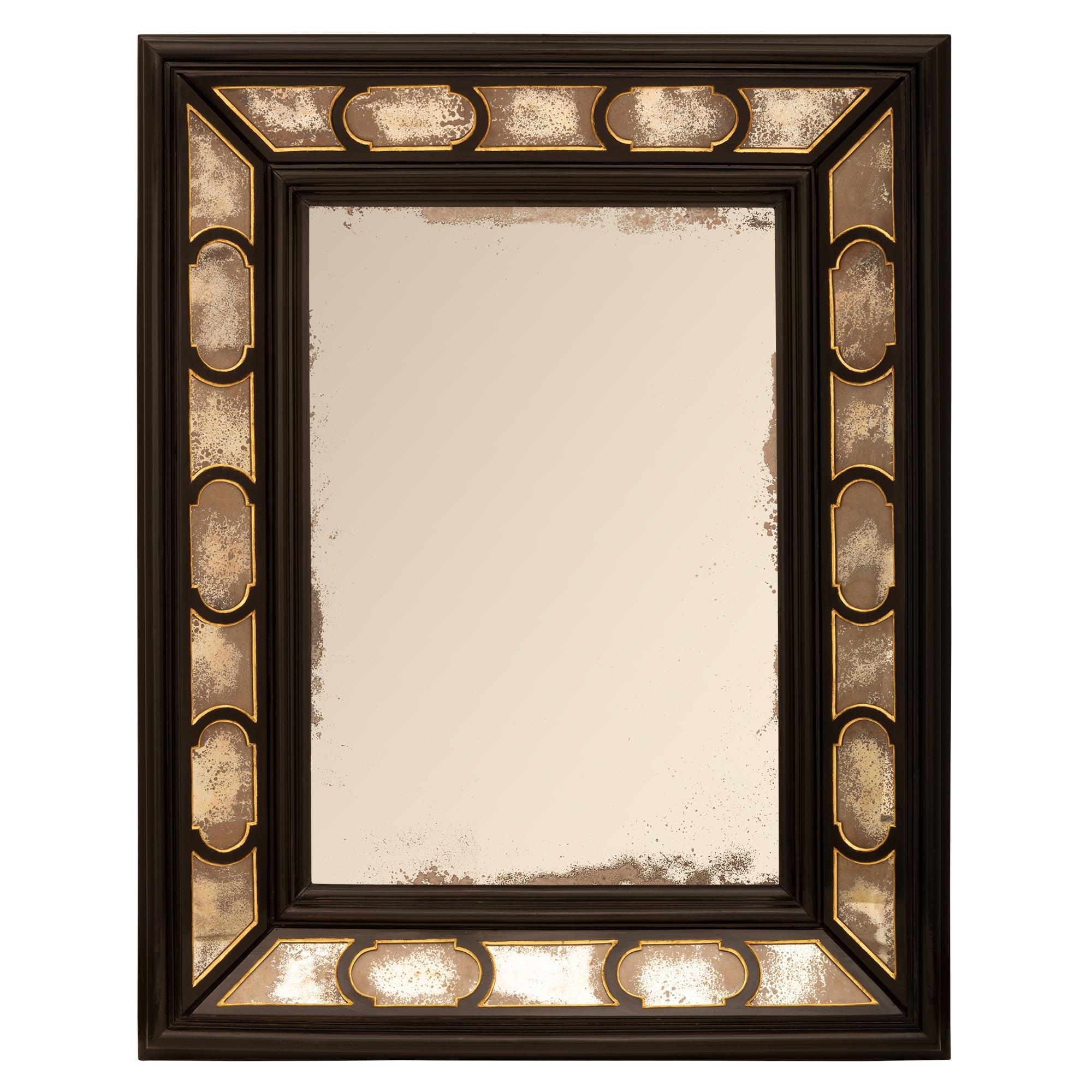 A striking and most decorative Italian 19th century ebonized fruitwood and giltwood double framed mirror. The mirror retains all of its original mirror plates throughout with the central plate framed within a fine wrap around mottled border. All of