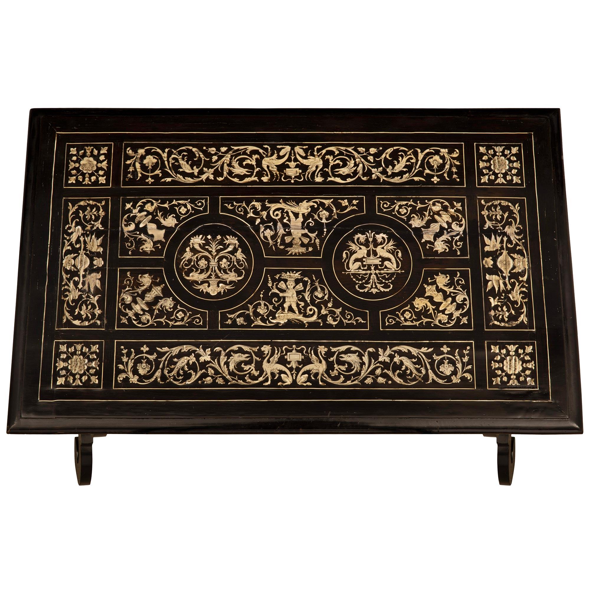An exceptional Italian 19th century Ebony and bone side table from Northern Italy circa 1870. The table is raised by beautiful most unique scalloped shaped supports with lovely scrolled designs decorated with fine bone inlaid fillets and connected