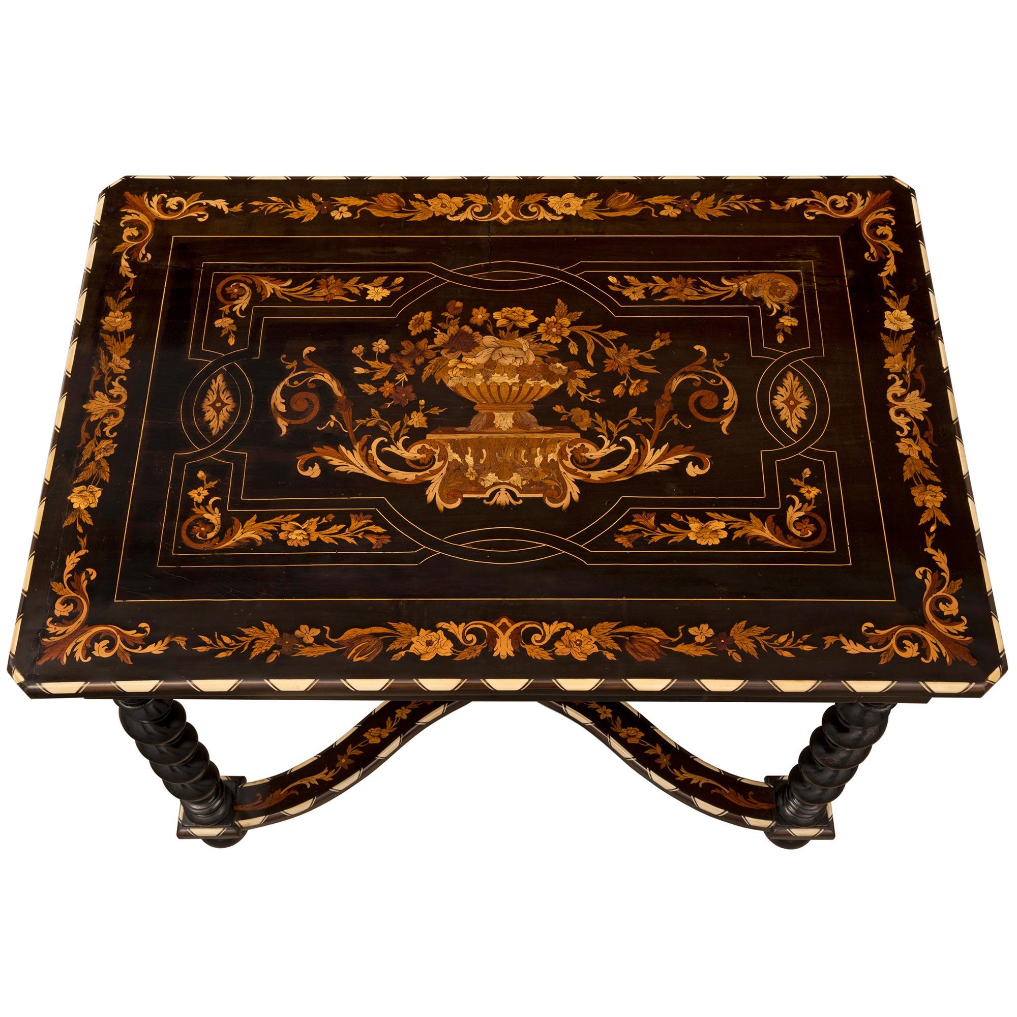 A stunning Italian 19th century ebony, bone and exotic wood center table / desk. The table is raised by fine bun feet below unique and most decorative carved spiral legs. Each leg is connected by an elegant scalloped 'X' shaped stretcher with