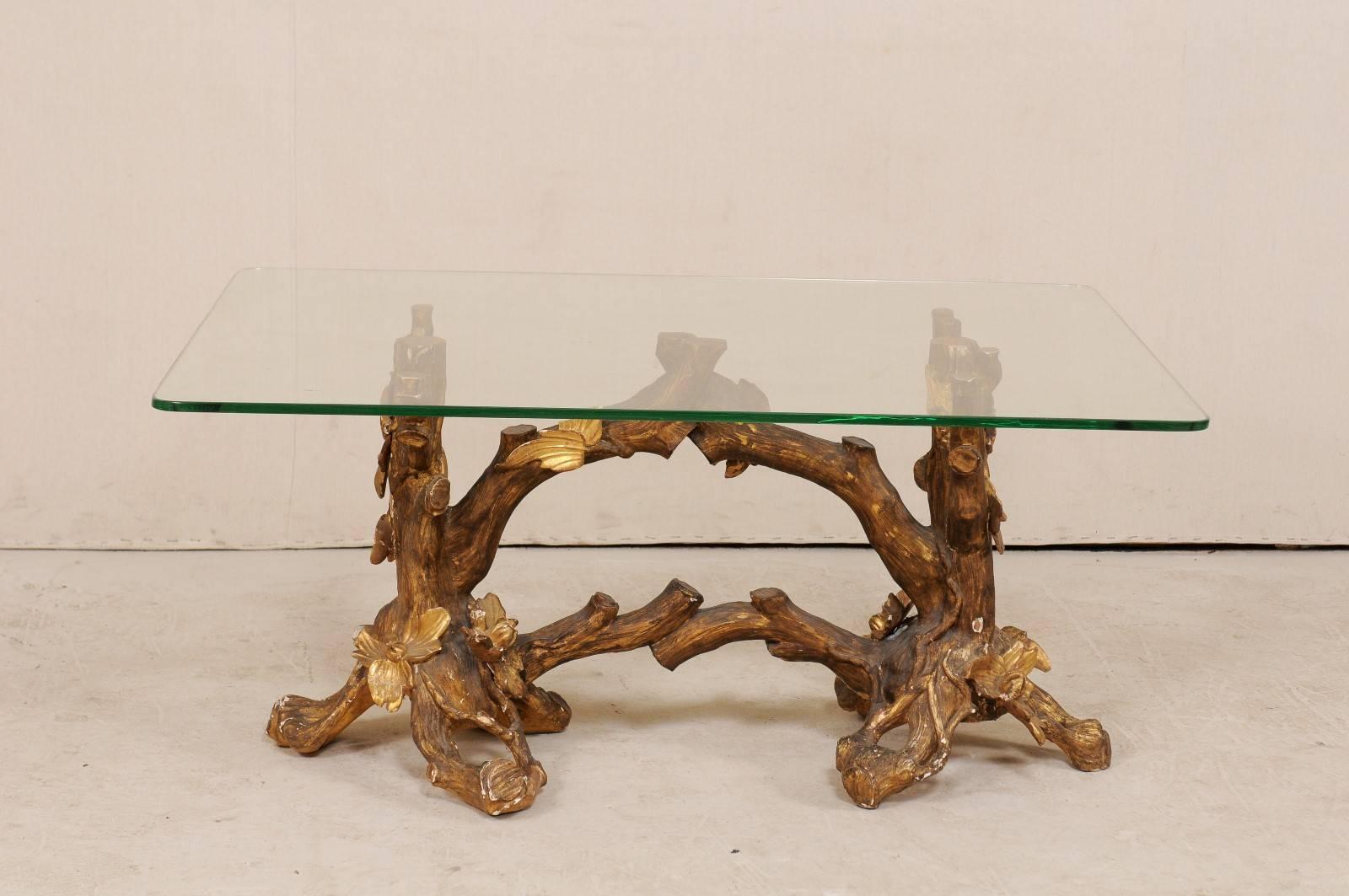 A 19th century Italian tree limb and floral carved wood base table with glass top. This antique Italian table features a hand-carved base in a cut flowering tree limb style with stunning display of realism. A rectangular-shaped glass top rests atop