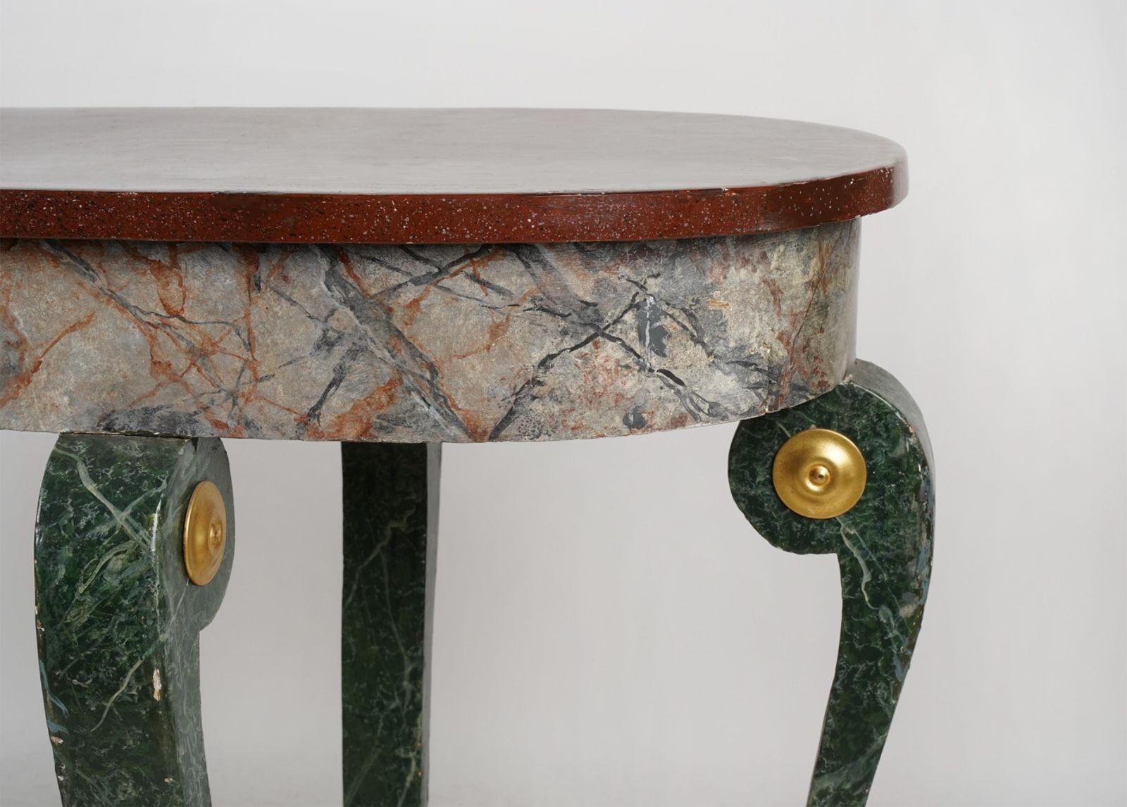 An alluring console table consisting of a faux veined marble frame and a faux red porphyry top. Made in Italy in the 19th Century. The colors of the piece give it a unique contrast to the whole table, making this a perfect furniture piece for any