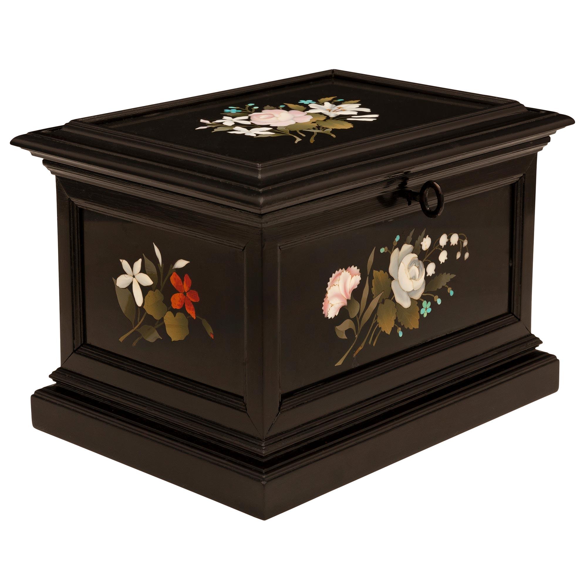 A charming and extremely decorative Italian 19th century Florentine st. Ebony and Pietra Dura marble box. The box is raised by an elegant stepped mottled base with striking wonderfully executed Pietra Dura plaques at each side. Each plaque displays