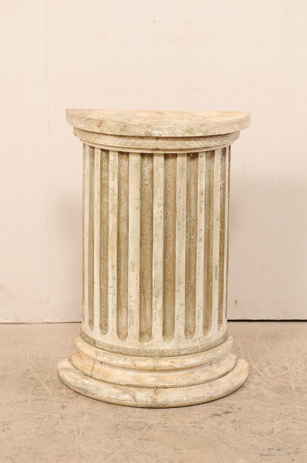 An Italian 19th century fluted half column. This antique wooden column from Italy features a half-round shaped with fluted body, rounded top and raised upon a stacked, semi-circular base. This pedestal is hallow, with flat back-side making it ideal