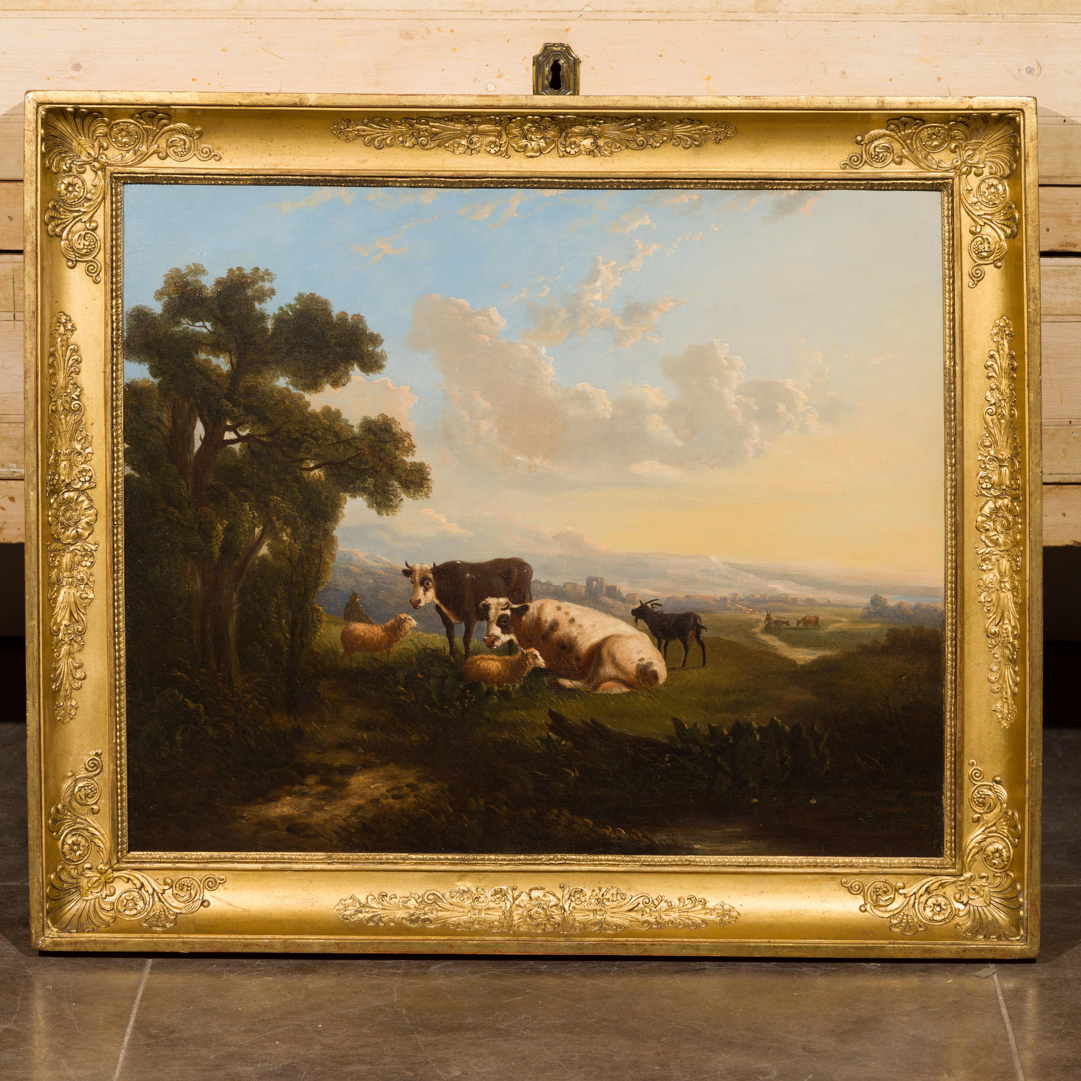 An Italian oil on canvas painting from the mid-19th century depicting cows, sheep and goats in pastures, in antique giltwood frame. Created in Italy during the third quarter of the 19th century, this horizontal oil on canvas painting depicts two