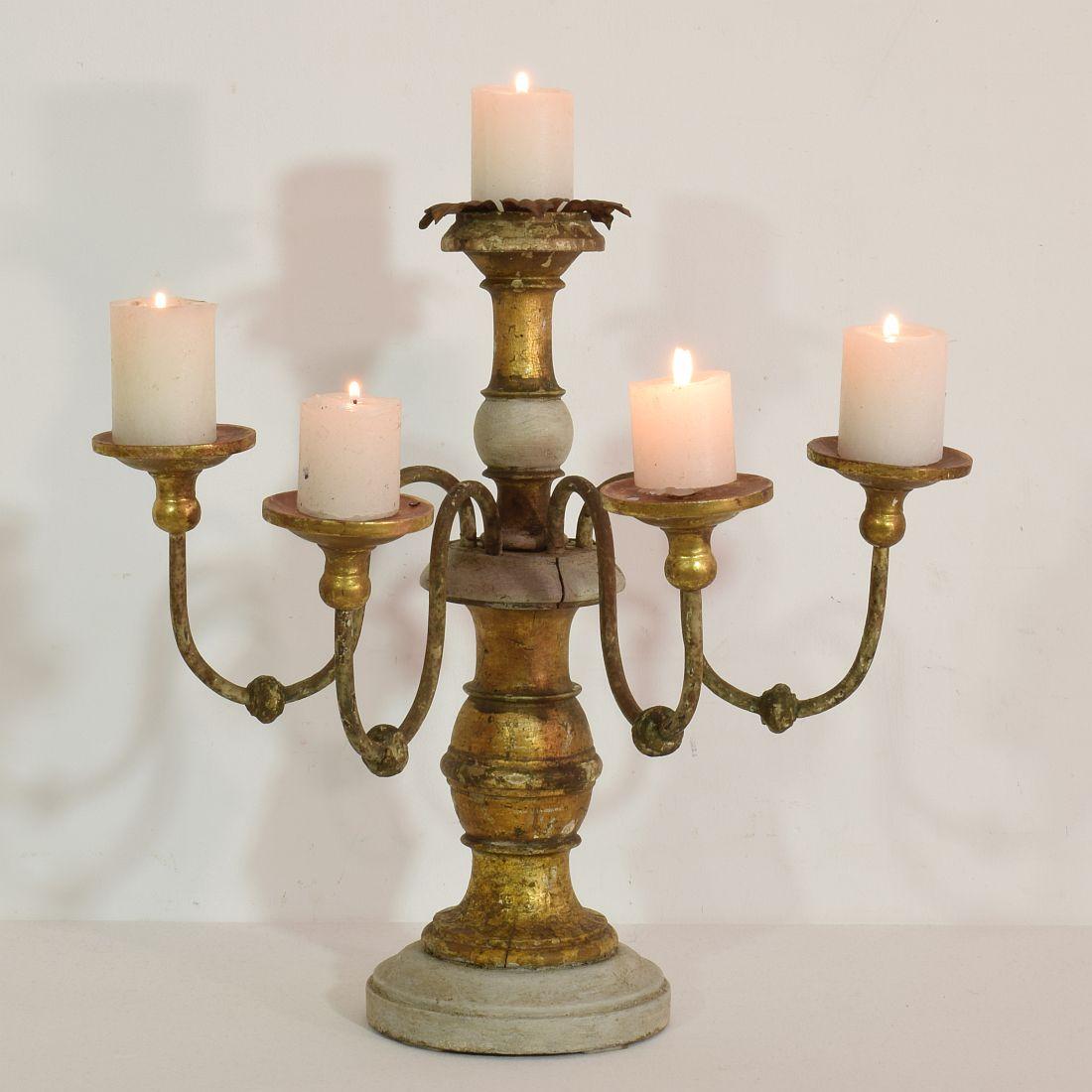 Beautiful candleholder with its original gilding and beautiful color.
Italy, 19th century. Weathered, small losses and old repairs. Measurement includes the iron peaks.