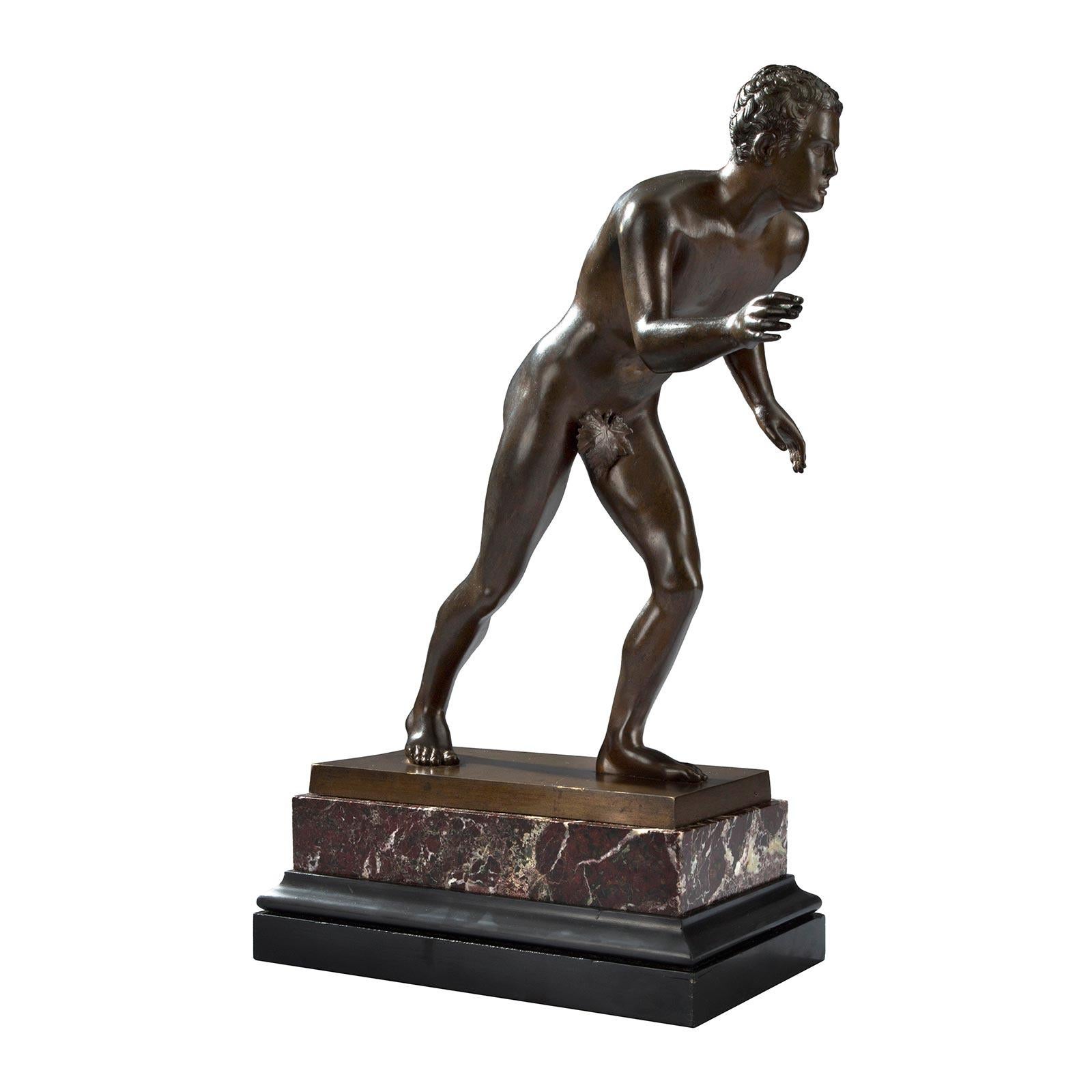 A handsome Italian 19th century Grand Tour period patinated bronze of a Roman athlete. The bronze is raised by a rectangular mottled edge black Belgian marble base below a thick rectangular Rosso Levanto support. The athlete is leaning forwards with