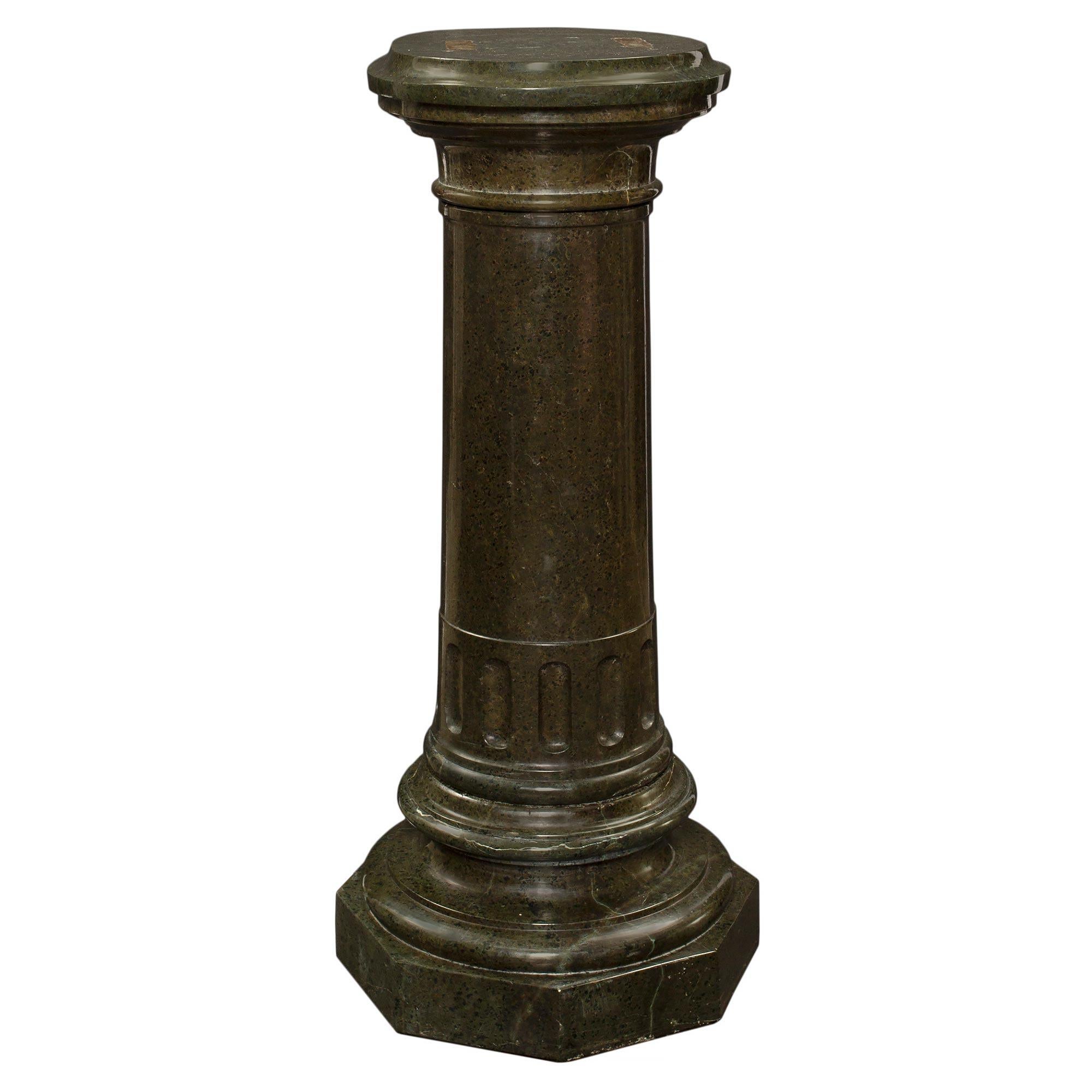 A handsome Italian 19th century green marble three piece pedestal. The pedestal is raised by a thick octagon base with a mottled design. The central column has flutes under the mottled swiveling 'D' shaped top.

  